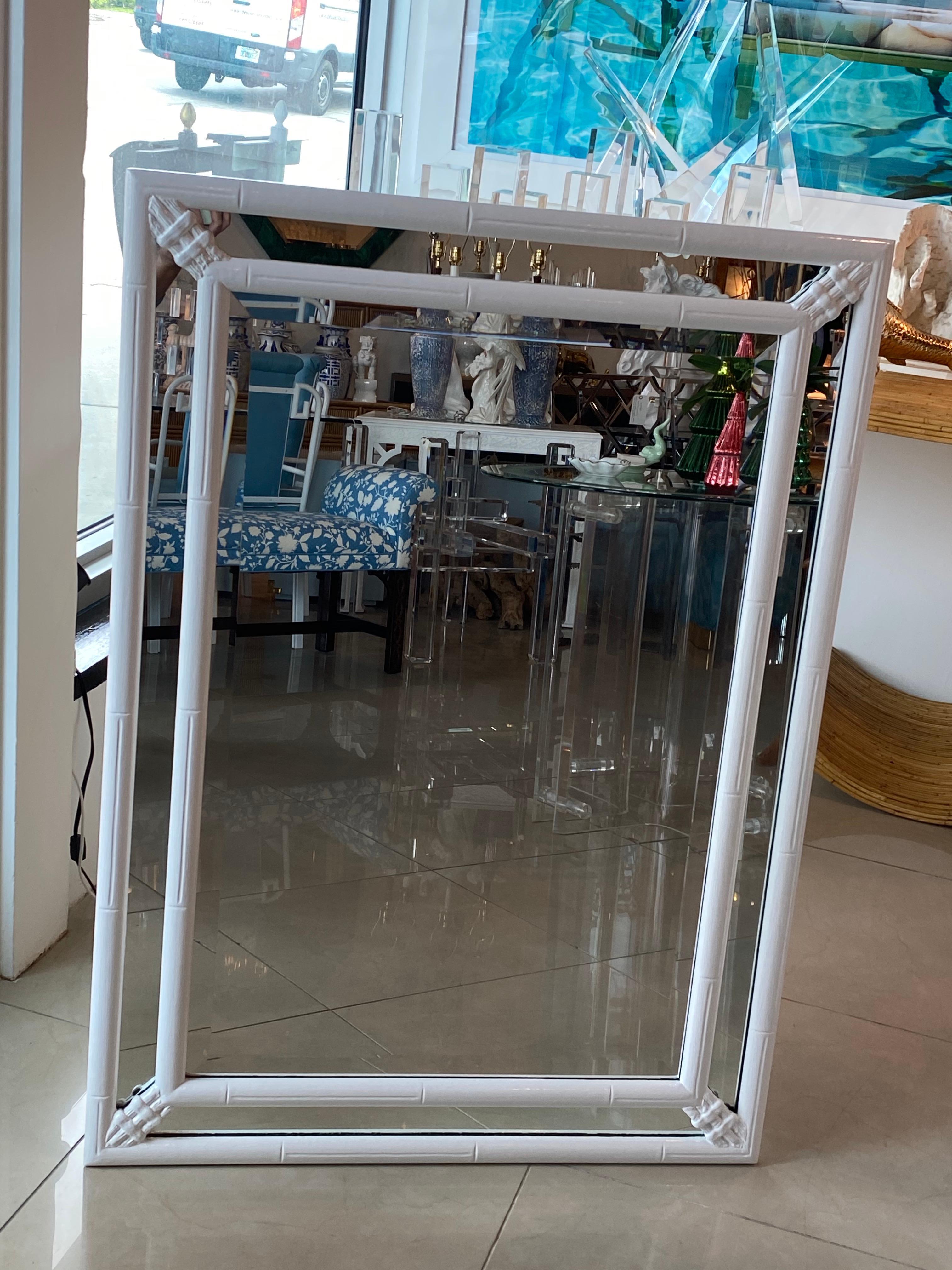 Lovely vintage faux bamboo white lacquered wall mirror. Newly lacquered. Original vintage mirror may have minor blemished to actual mirror insert. Can hang horizontal or vertical, comes with both options mounted on back.