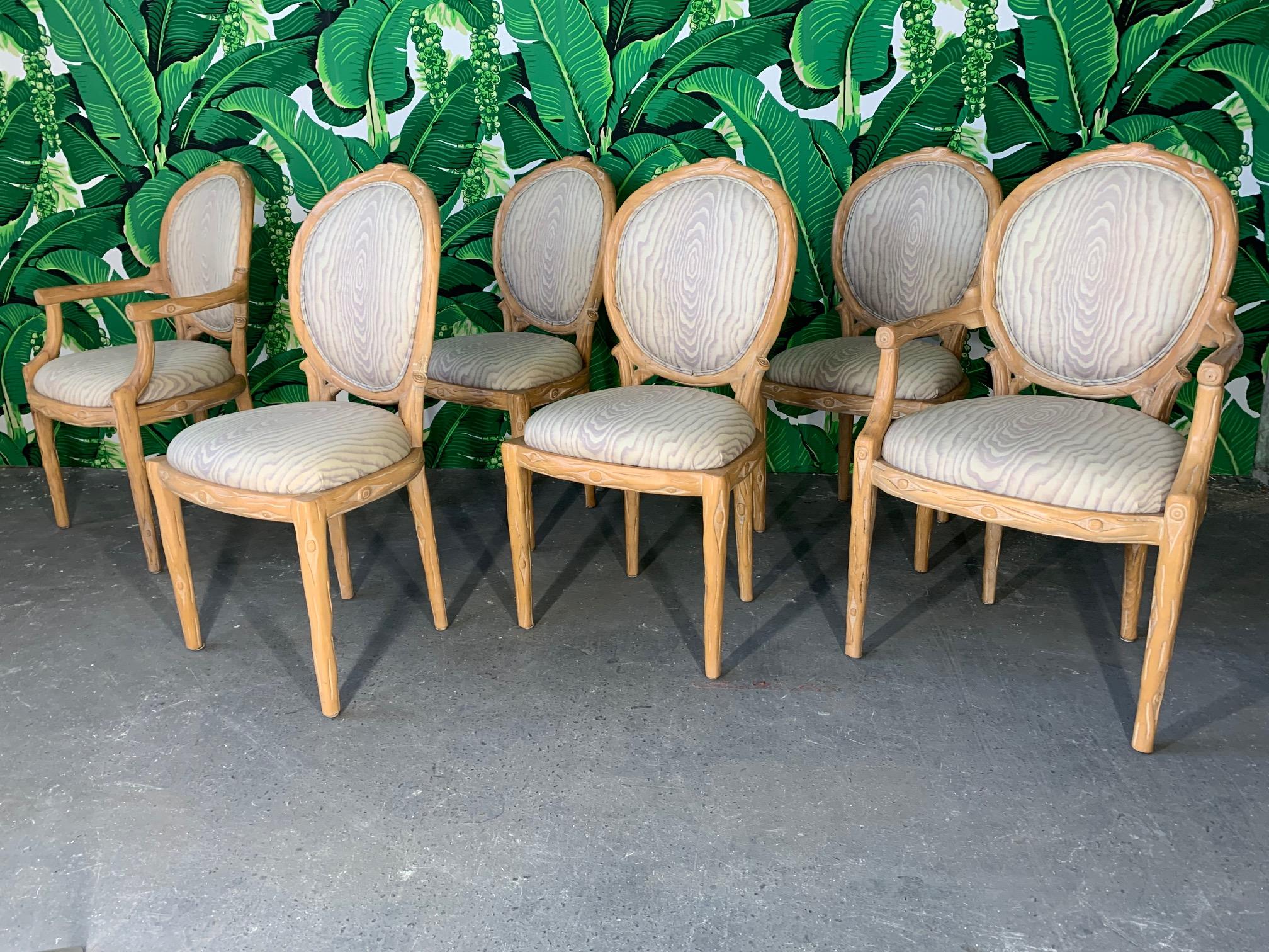 Set of 6 faux bois carved dining chairs in very good condition. Four side chairs and two arm chairs. Upholstery also in very good condition.