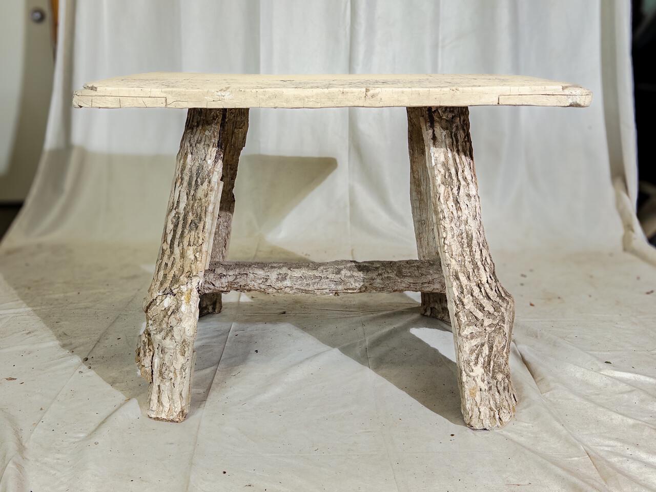 Transform your garden into a serene retreat with this charming Vintage Faux Bois Garden Table. Crafted with intricate detail, it portrays the timeless elegance of wood, yet boasts the durability of weather-resistant materials. Its Faux Bois design