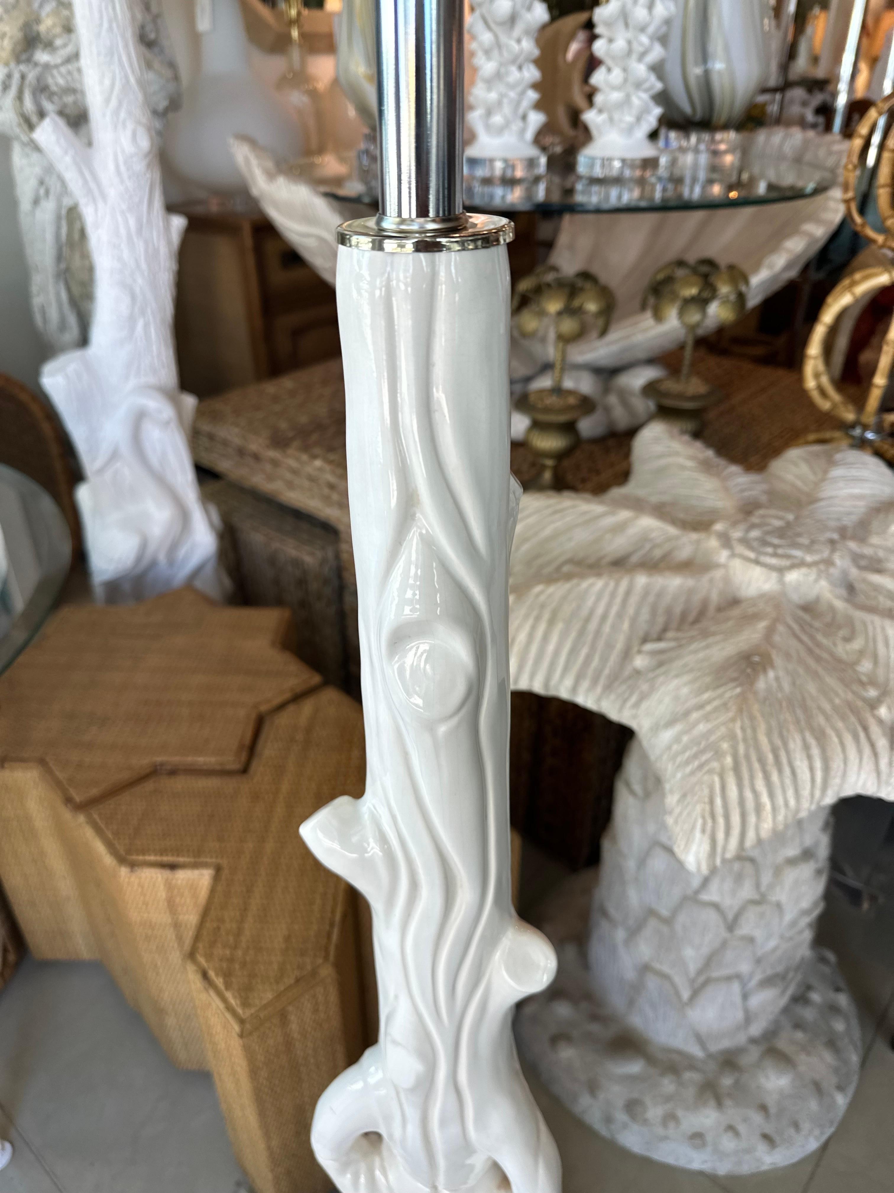 Vintage ceramic faux boise tree trunk floor lamp. This has been newly wired with 3 way sockets, all nickel hardware. The wood base has been lacquered in a fresh white. Dimensions: 56 H (to top of finial) x 49.5 H (to top of socket) x 16 D. If you