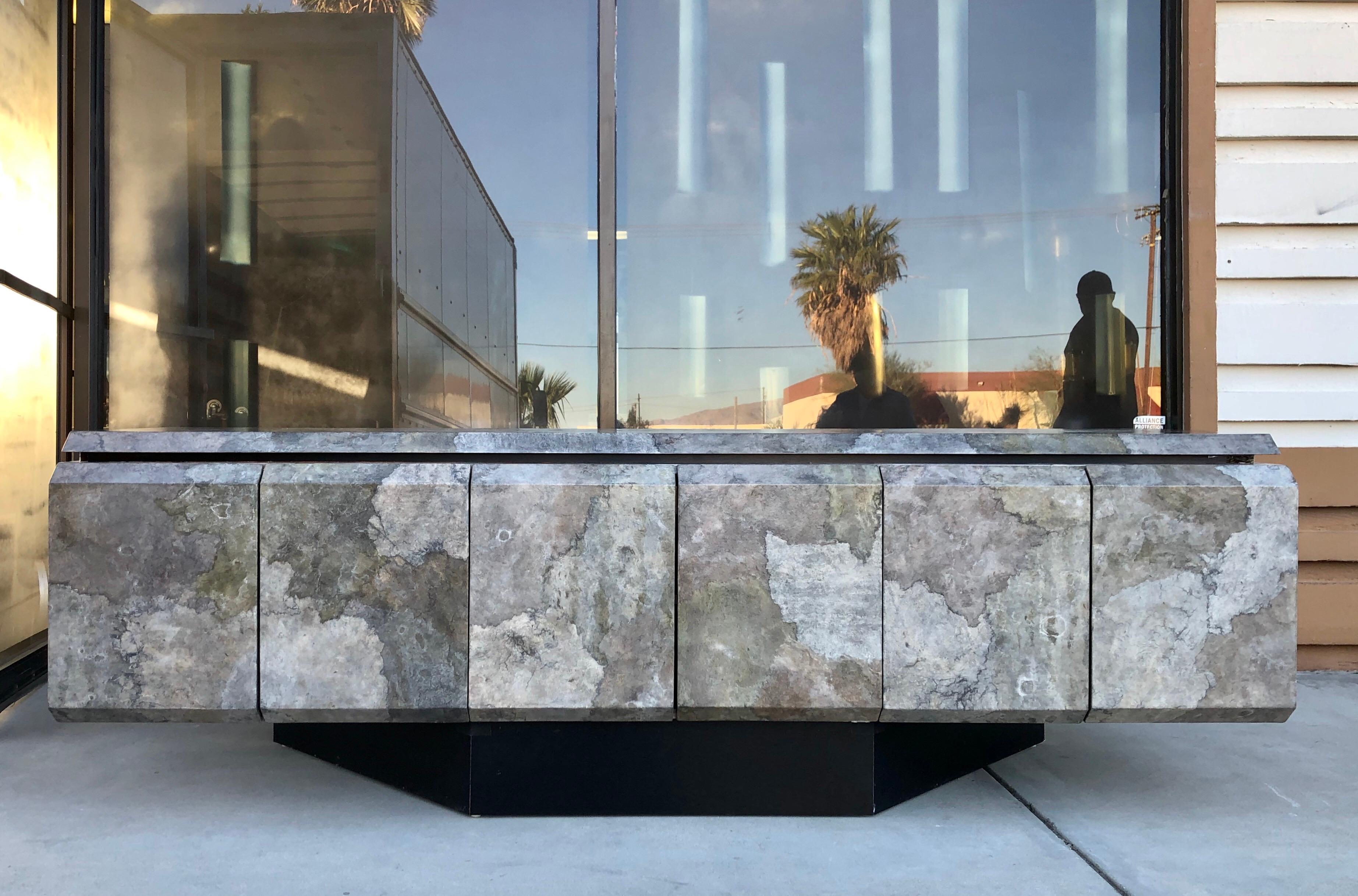 This sideboard is spectacular. It was custom made for a Palm Springs estate and is done with a faux goatskin finish that is extremely dimensional and beautiful. Colorations are melange of gray, silver, and greenish undertones metallic. The