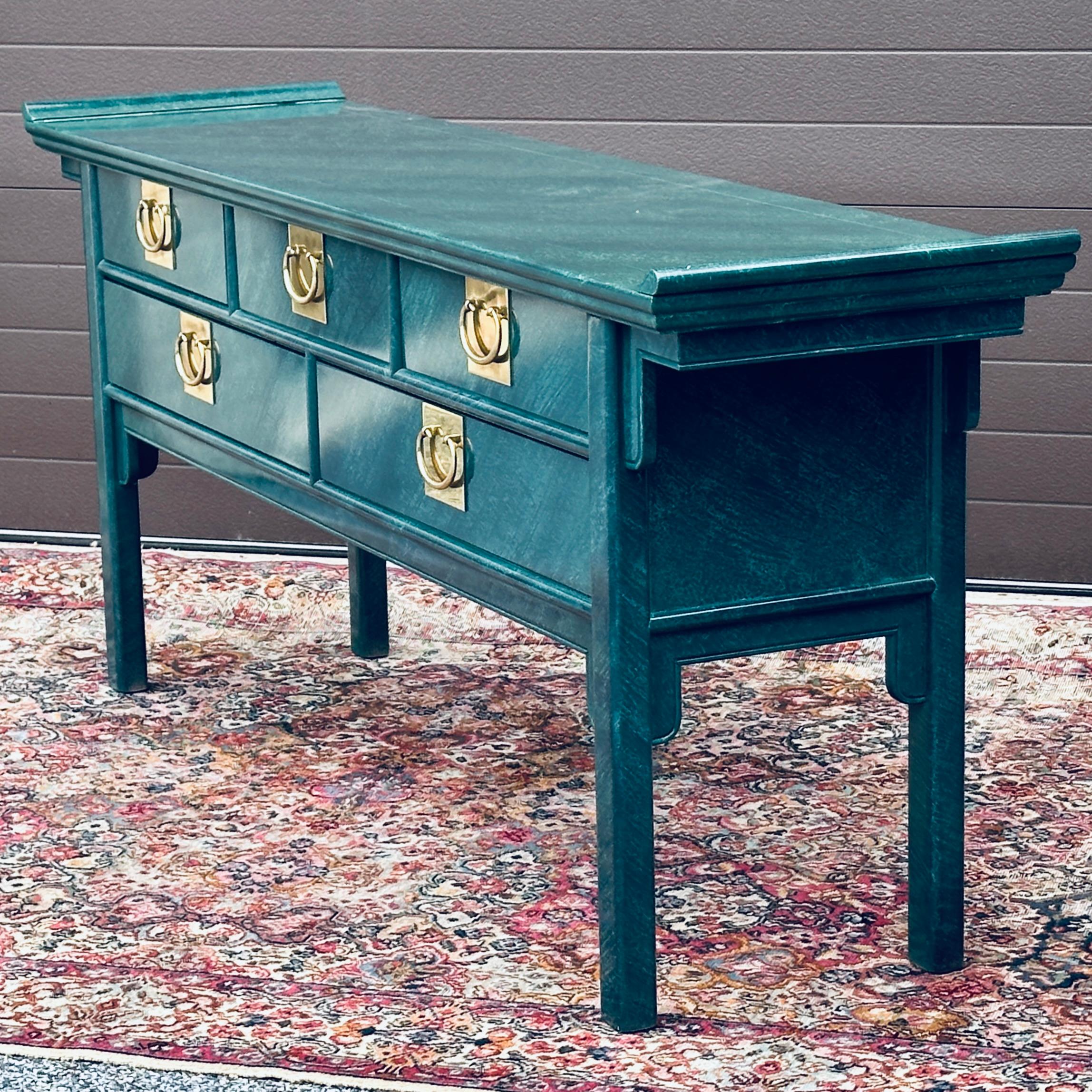 Pagoda shaped chinoiserie style console table and mirror set with the original faux malachite finish. Features five drawers with big brass hardware and generous storage capacity. Faux finish on all sides including back. Attributed to Century