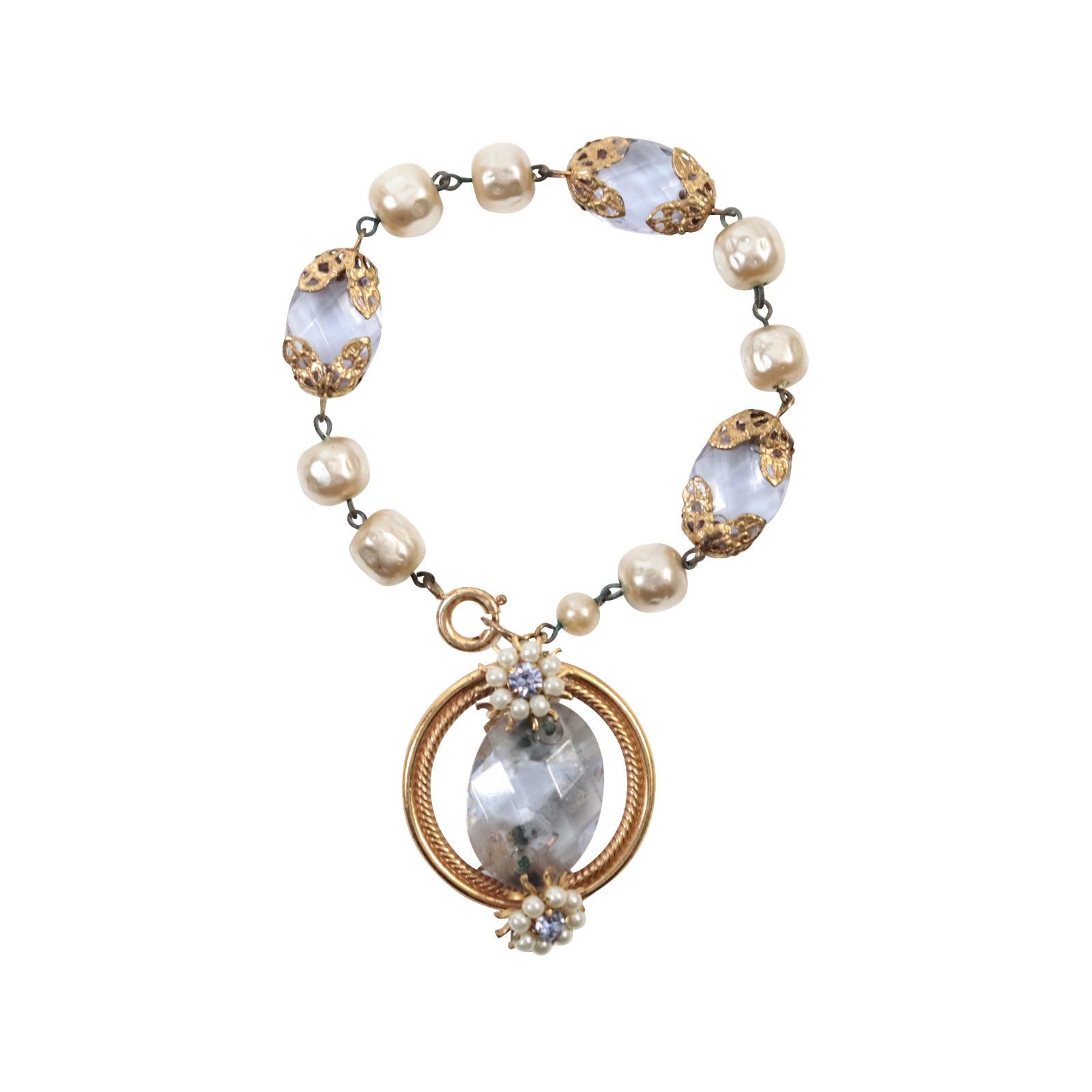 Vintage Faux Pearl Dangling Bracelet  With Lavender Crystal Pieces, Circa 1960s.  This is a bracelet that will never go out of style.  You can wear it for a black-tie event or to elevate your sweater, t-shirt, and jeans.  This is a faux pearl