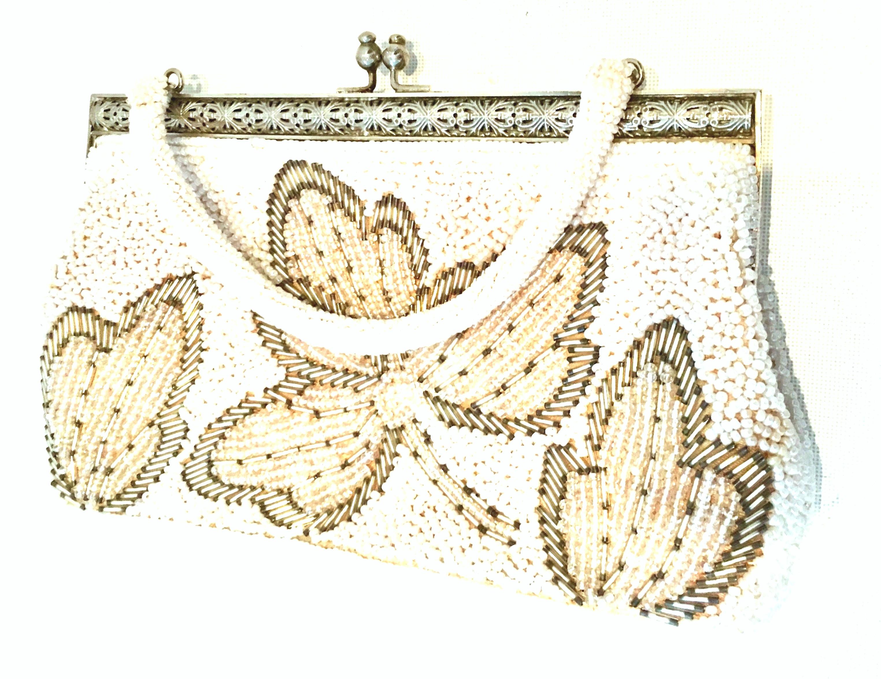 20th Century faux pearl & silver glass hand beaded Hong Kong evening bag. This rare floral motif Hong Kong bag features shimmering,  tiny pearl ascent white beads with iridescent faux pearl beads and silver glss beads in a raised floral double sided