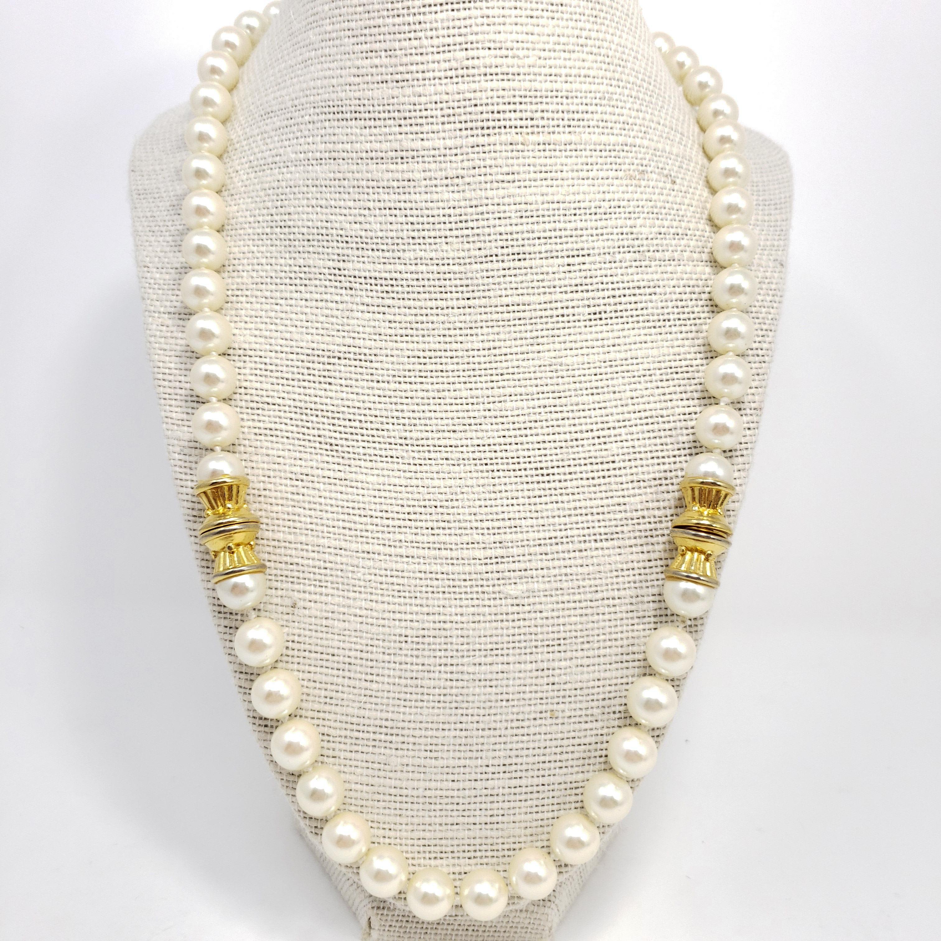 Vintage pearl necklace, featuring a single, 22 inch strand of white faux pearls decorated with two gold-tone accents. An exquisite accessory!
