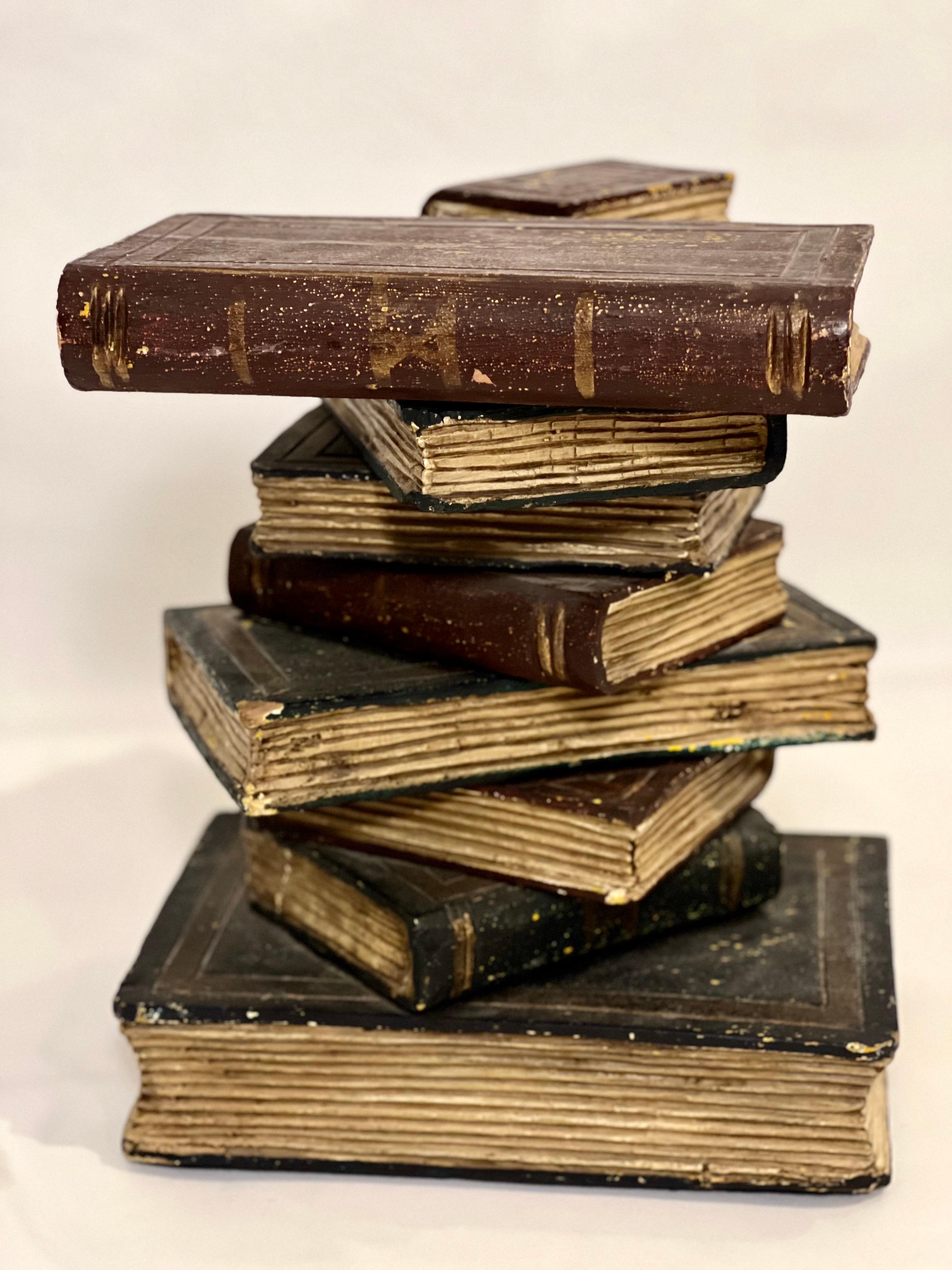 Vintage faux stacked book sculptural wood side table.

Great table featuring nine wood faux books in lifelike stacked form. Each book has realistic texture with painted gold details and intricately carved pages. The table's rustic character and deep