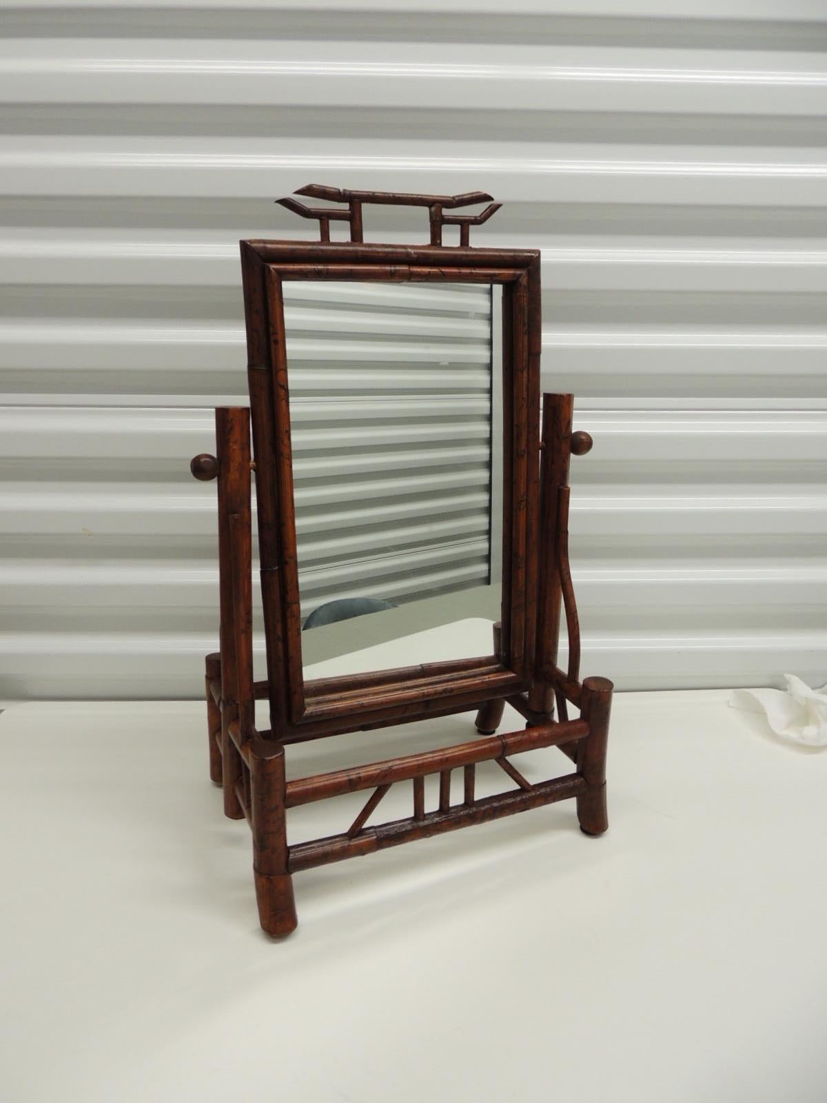 Vintage faux tortoise bamboo vanity table mirror on stand.
Mirror swivels.
Size: 12.5