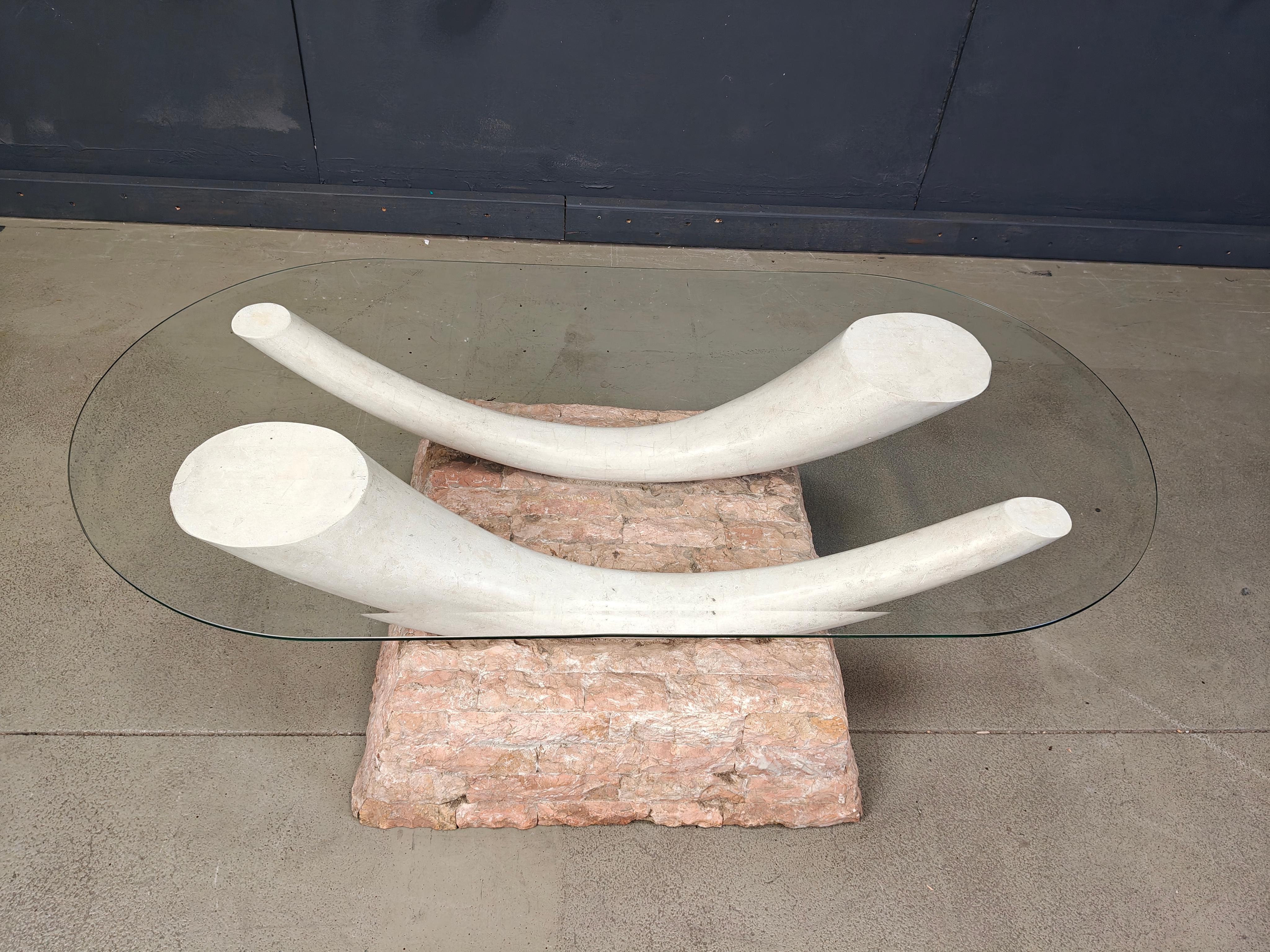 Striking vintage faux tusk coffee table made from tesselated stone with a beveled clear oval glass top.

Beautiful and elegant coffee table which will be, without a doubt an eye catcher in your living room.

1980s - Italy

Good condition

Height: