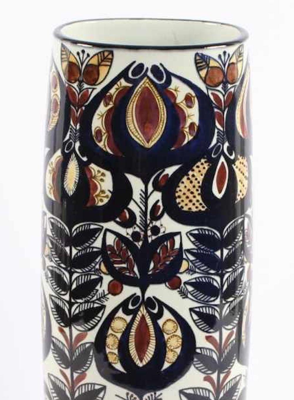 This Faience vase is an original decorative object realized in 1968 by Berte Jessen (BJ).

Beautiful barrel-shaped vase from Royal Copenhagen. Designed by Berte Jessen, for the Tenera range. The design is floral and in shades of blue with