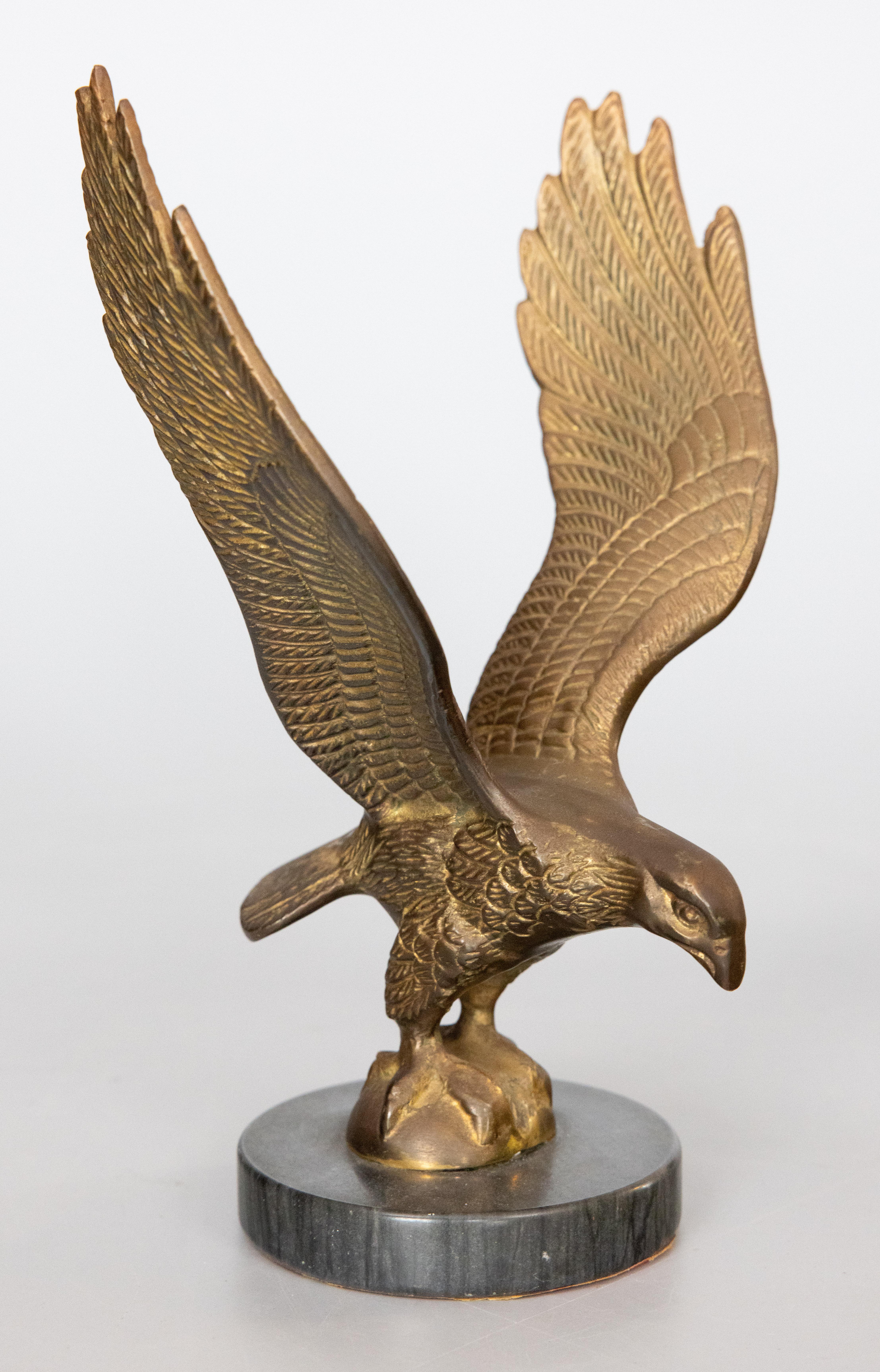 Beautiful finely-crafted brass vintage eagle sculpture or paper weight with a lovely patina. It is solid and heavy, weighing a substantial 3 1/2 lbs, with very fine details and a gorgeous marble base. It would be handsome on a bookcase or desk and