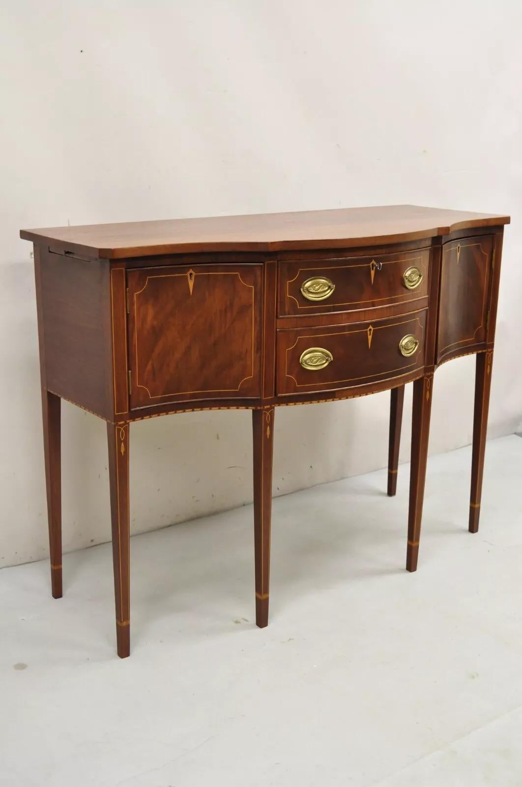 Vintage Federal Style Mahogany Inlaid Serpentine Sideboard Buffet by Copenhaver's Furniture, Winchester, VA. Item features pull out sides, working lock and key, bellflower and satinwood inlay, tall tapered legs, 2 dovetailed drawers, 2 swing doors,
