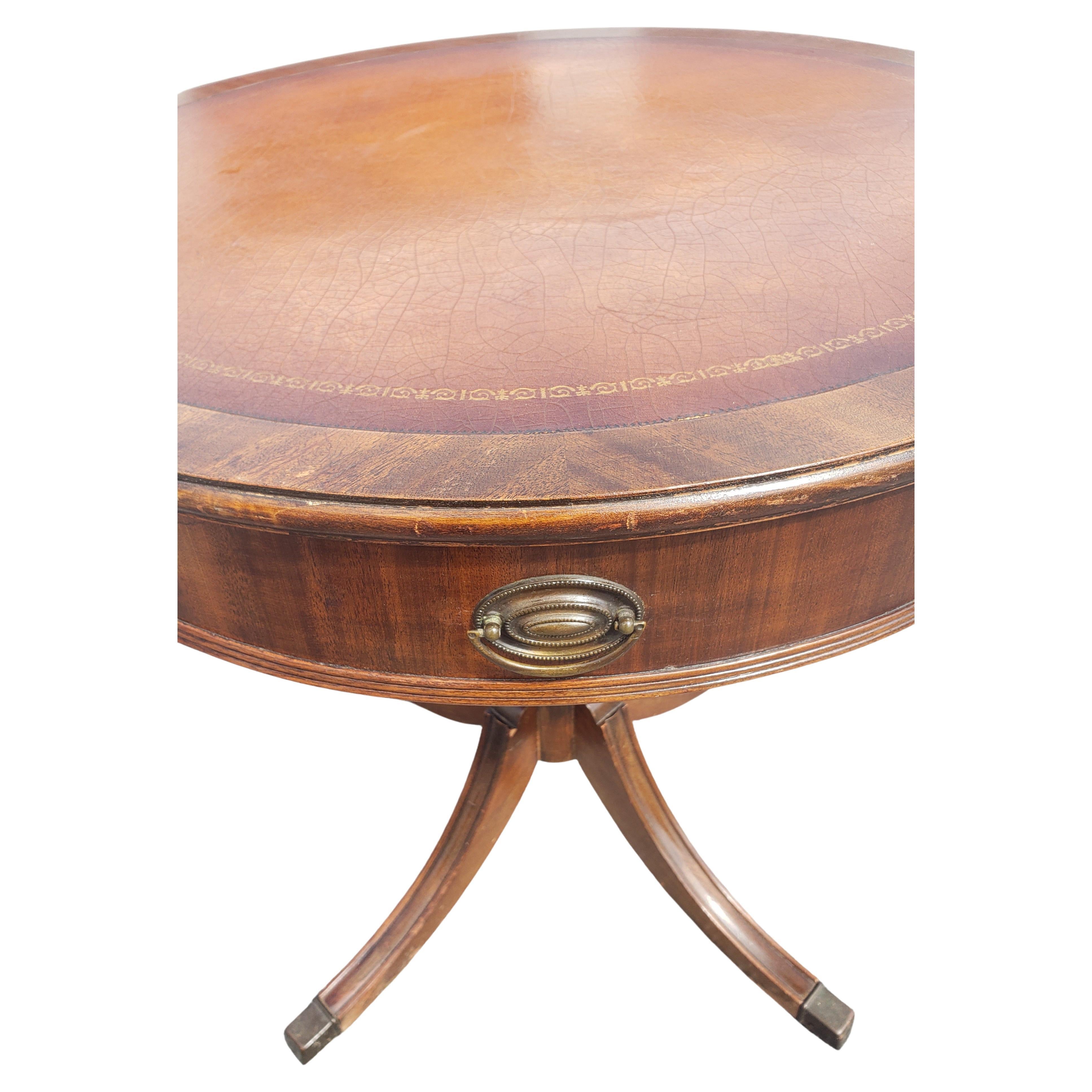 We are pleased to offer this gorgeous Antique Hekman Regency Style drum table from the 1940s. Hekman furniture company of Grand Rapids, MI has been around since 1922 and still makes some of the highest quality case goods in the industry today. From