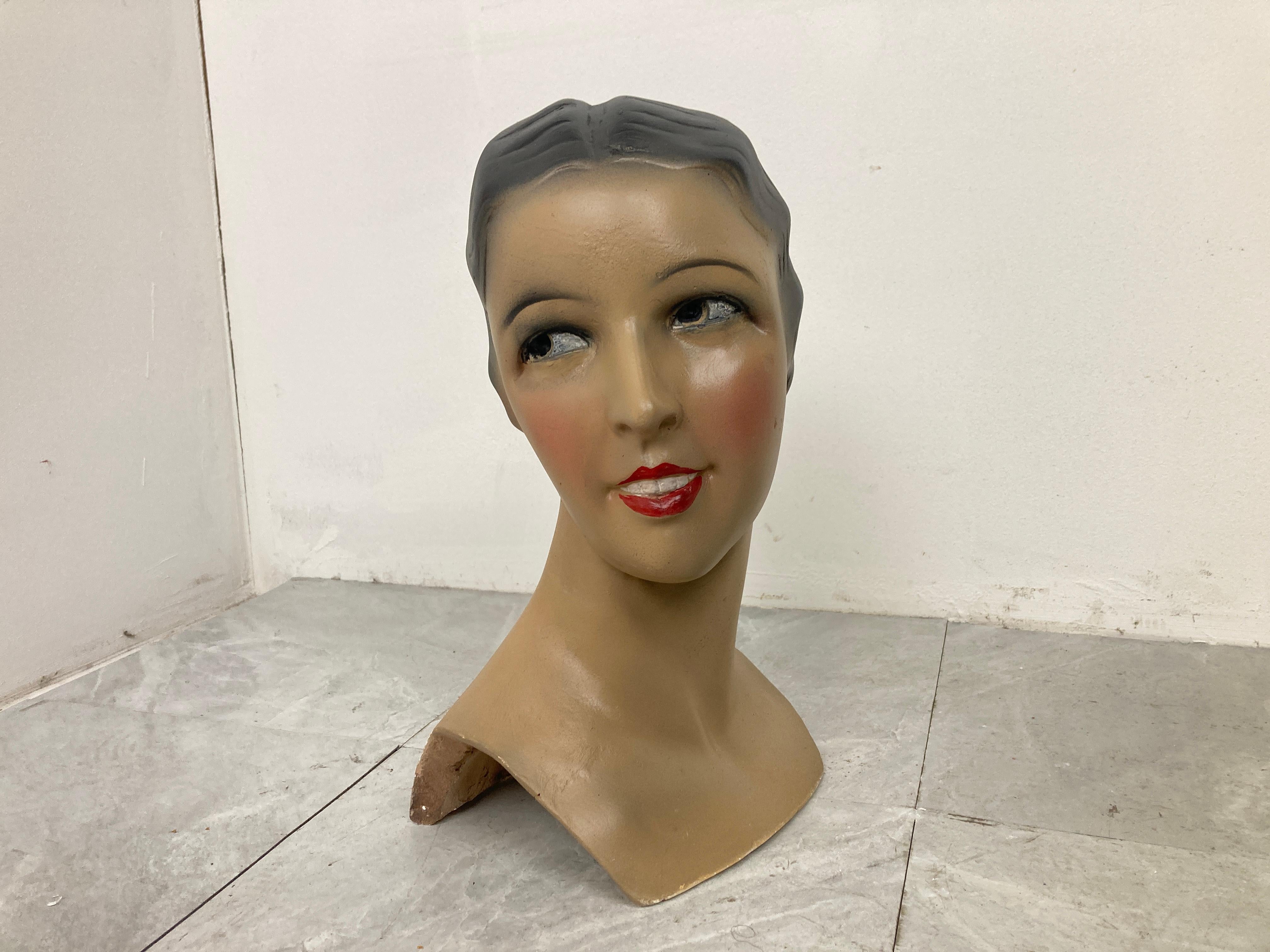 Beautiful female mannequin head made from plaster servings as an advertising bust in a shop.

It was used to be displayed at a shopcounter or vitrine.

It has some minor user traces.

Comes from a lot acquired from a clothes shop that stopped