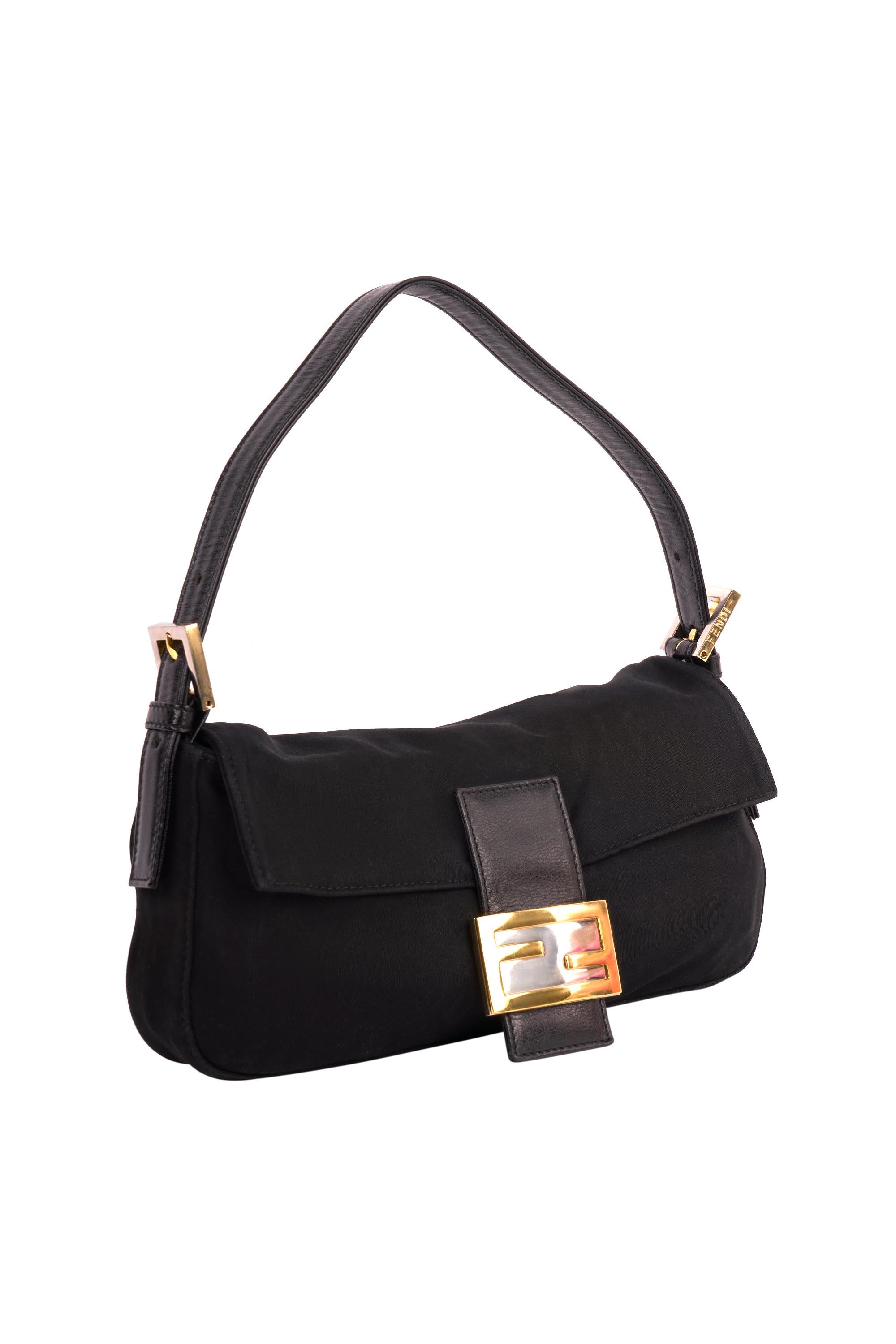 Vintage Fendi 1990's Schulter Baguette Tasche. Mit schwarzem Wildleder, verstellbarem schwarzem Leder mit goldenen Fendi Schnallen, Fendi Symbolen  und goldfarbener Metallklappe mit Magnetverschluss und hinterer Innentasche mit Reißverschluss.

In