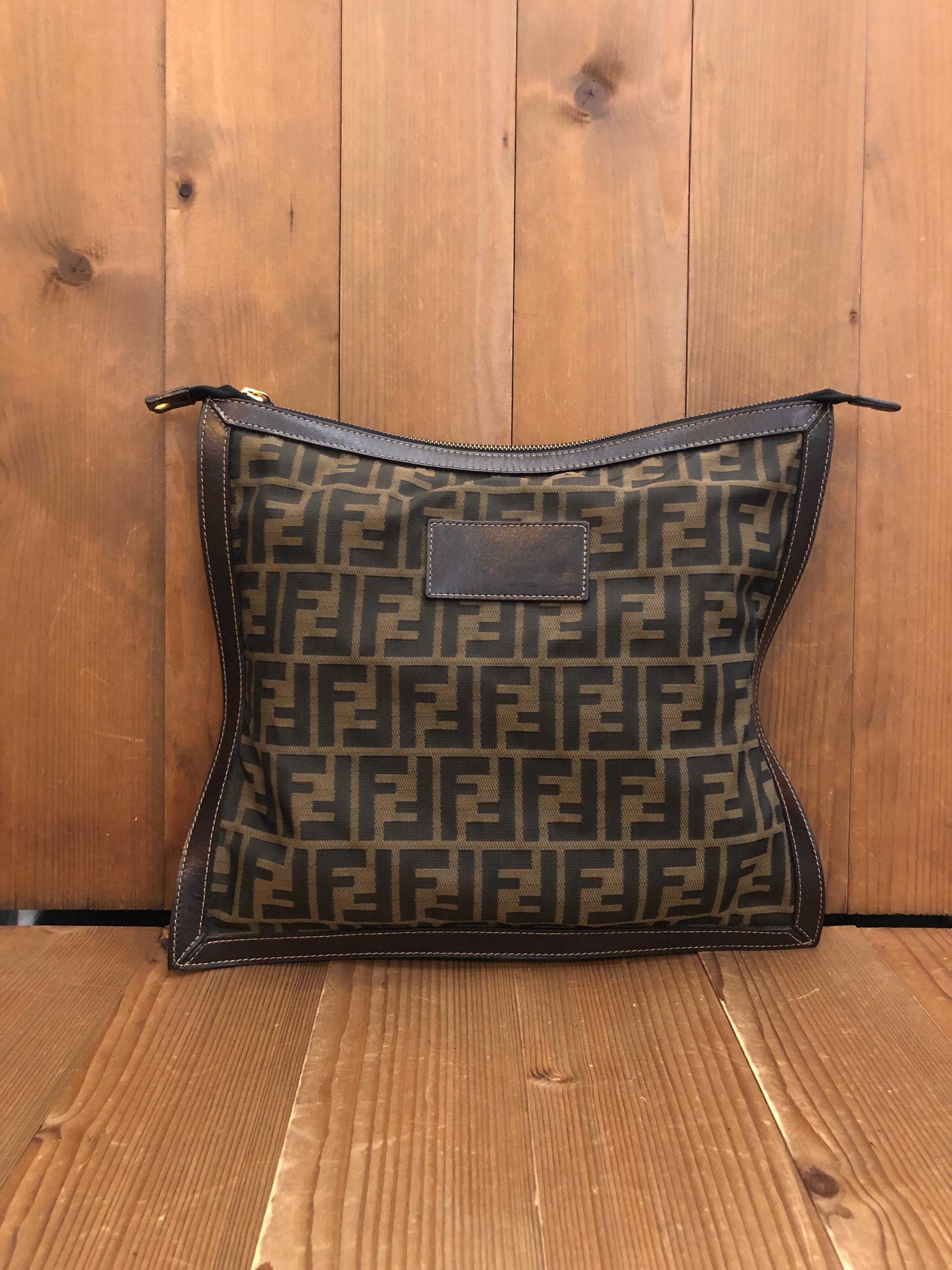 This vintage FENDI flat pouch is crafted of Fendi's iconic Zucca jacquard in brown trimmed with brown smooth leather. Top zipper closure opens to an un-lined interior. Third party eyelets and rope strap are added. Measures approximately 11.5 x 13