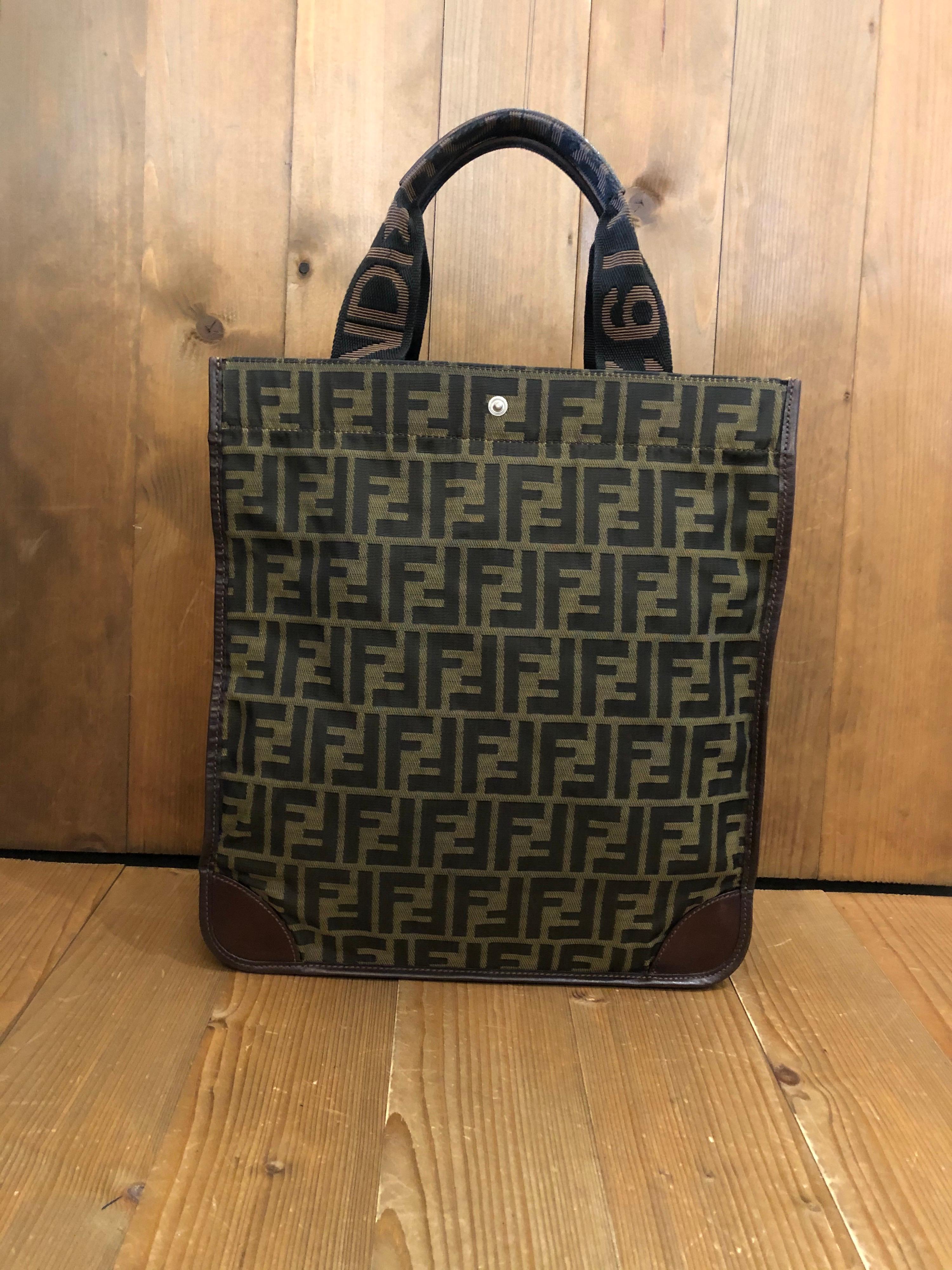 This 1990s Fendi foldable tote bag is crafted of Fendi's iconic brown Zucca jacquard and brown leather featuring two nylon handles lined with the same leather for comfort. Wide top opens to an unlined interior. This vintage Fendi features a snap