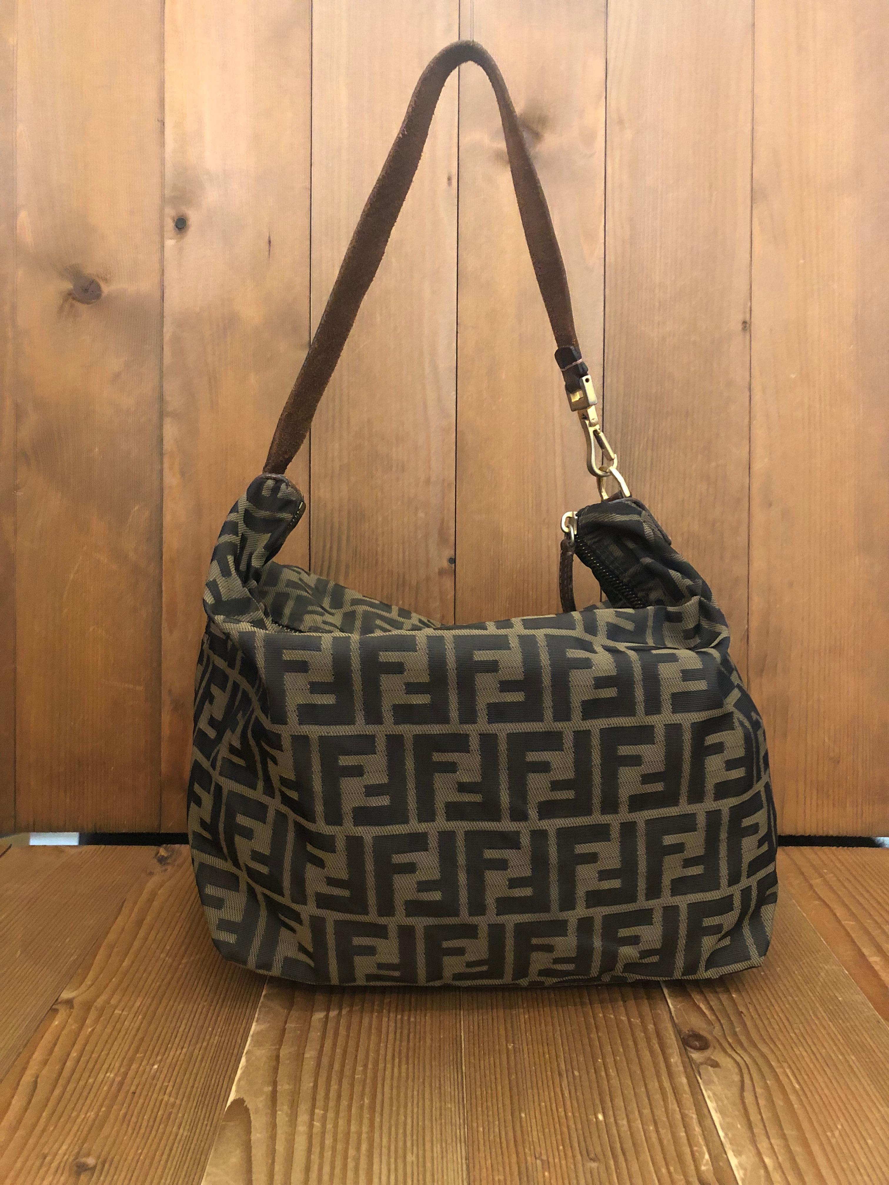 Vintage Fendi shoulder bag in Fendi's iconic brown Zucca jacquard trimmed with brown leather featuring gold toned hardware. Zipper top closure opens to an un-lined interior. Made in Italy. Measures 9 x 9 x 6.25 inches Strap drop 9