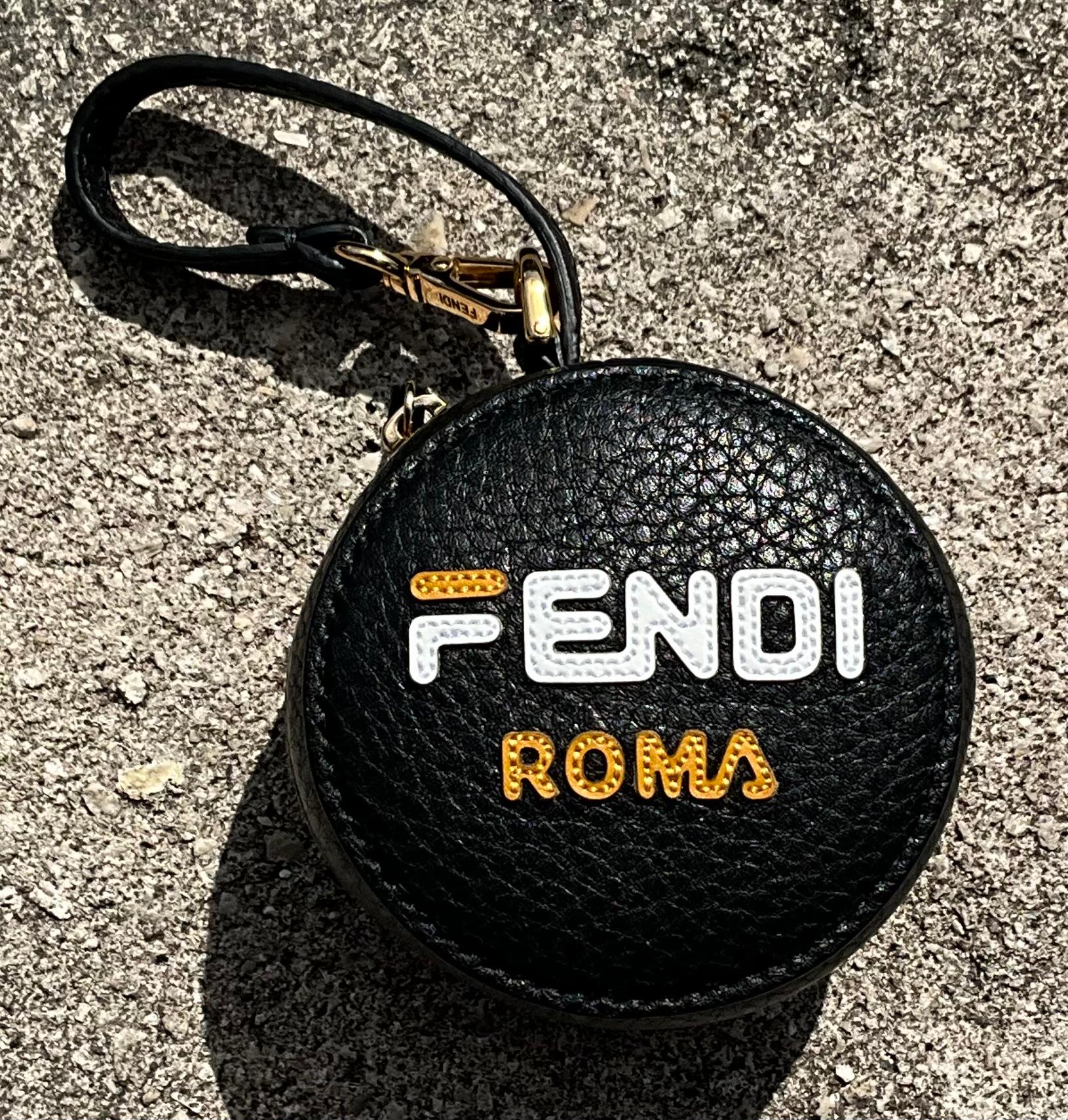 This Vintage Fendi Fila Mania Bag Charm features the iconic Fendi and Fila collaboration logo, typically rendered in bold, eye-catching colors and patterns that reflect the spirit of the Fila Mania collection. The charm is usually crafted from