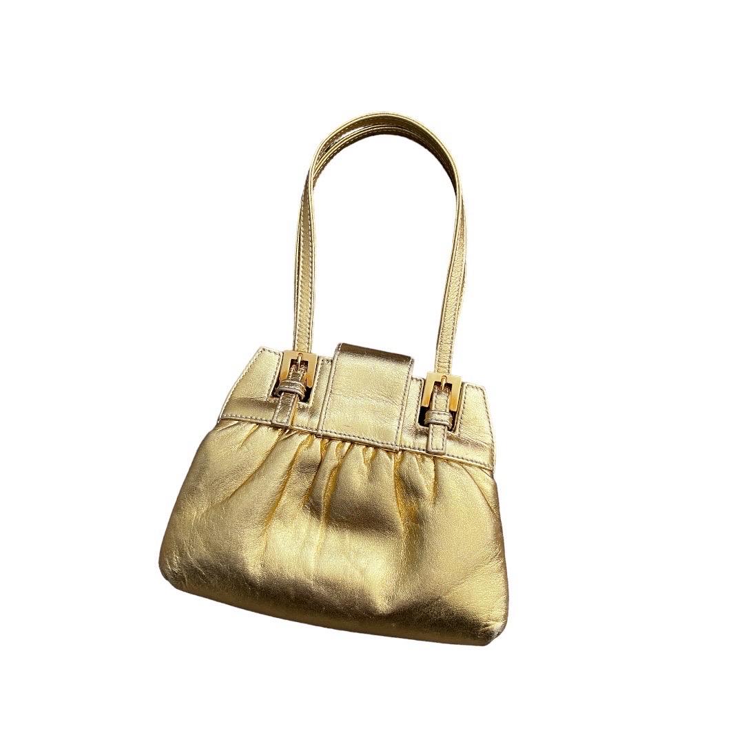 Adorable golden leather rhinestone handbag
Minor scratches on the hardware
Minor scratches on the exterior 
Two small spots on the interior are not noticeable.
No noticeable flaws
