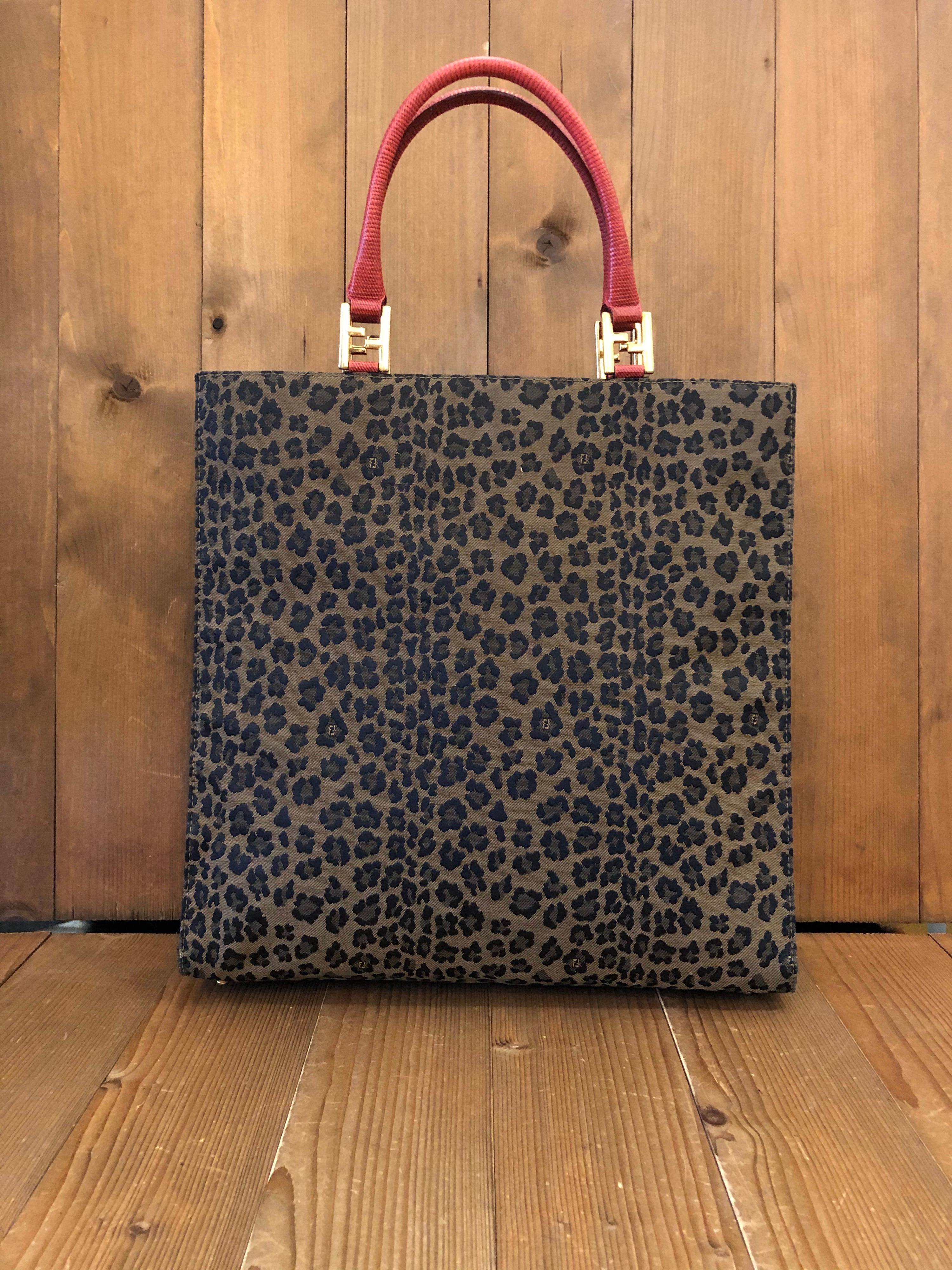 1990s Fendi book tote in brown and black leopard printed jacquard featuring one interior zip pocket. Made in Italy. Measures 13.5 x 13.5 x 4 inches Handle drop 6 inches

Condition - Minor signs of wear. Generally in good condition.

Outside: Minimal