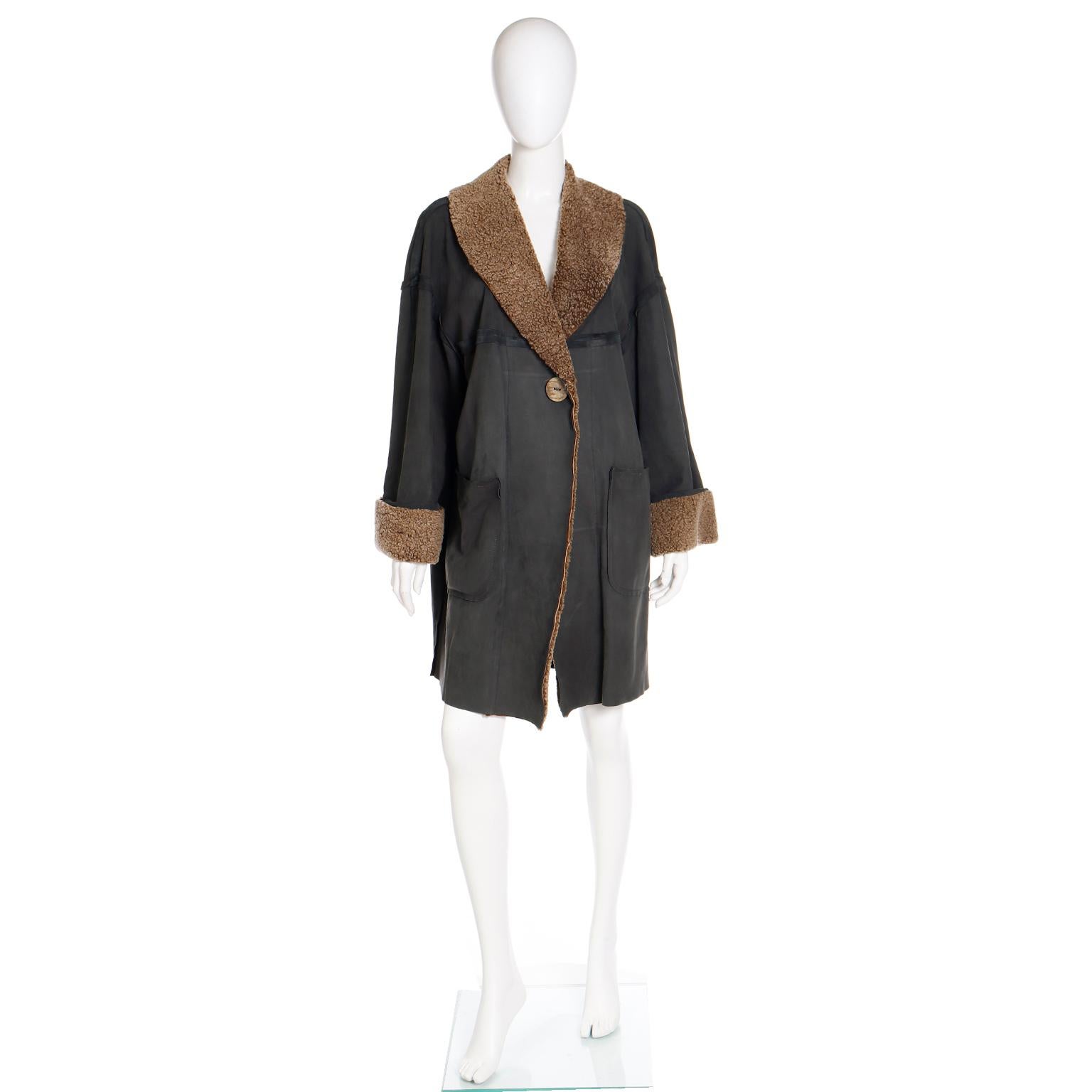 This is a super easy to wear vintage Fendi grey green shearling jacket with lambswool trim at the collar and cuffs. Unlike most shearling coats, this one is very lightweight and can be worn warmer climates. The jacket has front patch pockets and
