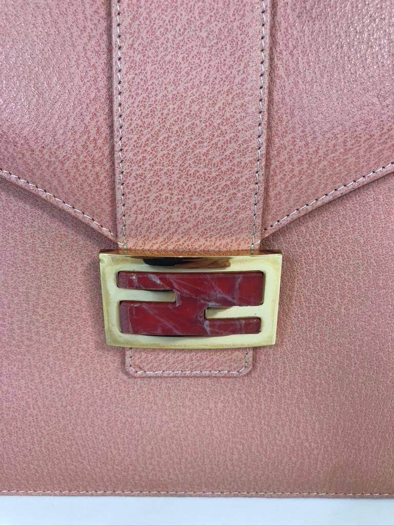 Vintage Fendi pink leather top handle bag with marble on logo clasp. Condition: Excellent, never used. 

9.5
