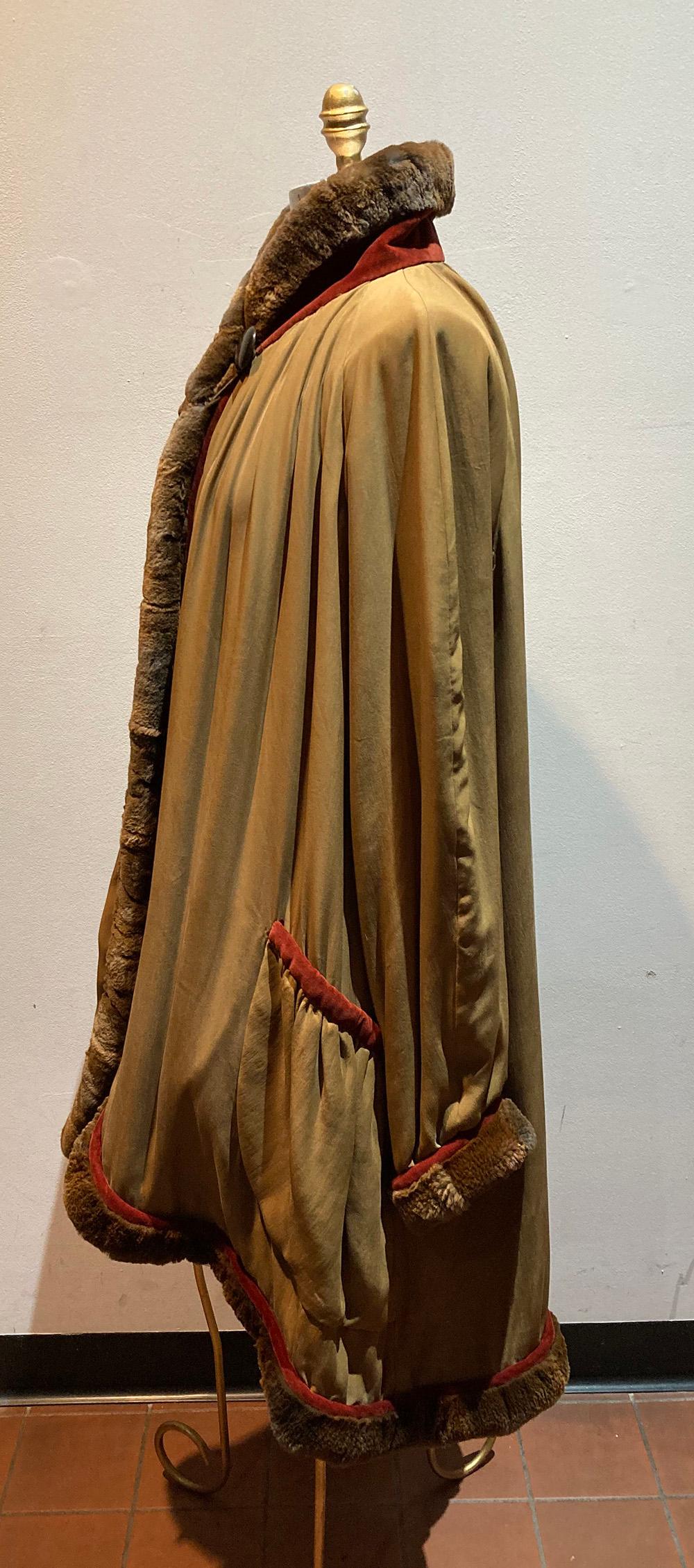 Vintage Fendi Silk Fur Coat in excellent condition. Soft Tan silk trimmed with brown rabbit fur collar and deep red velvet. Single top collar button closure opens to matching tan sateen lining. Absolyrely gorgeous drape to this piece. Raglan style