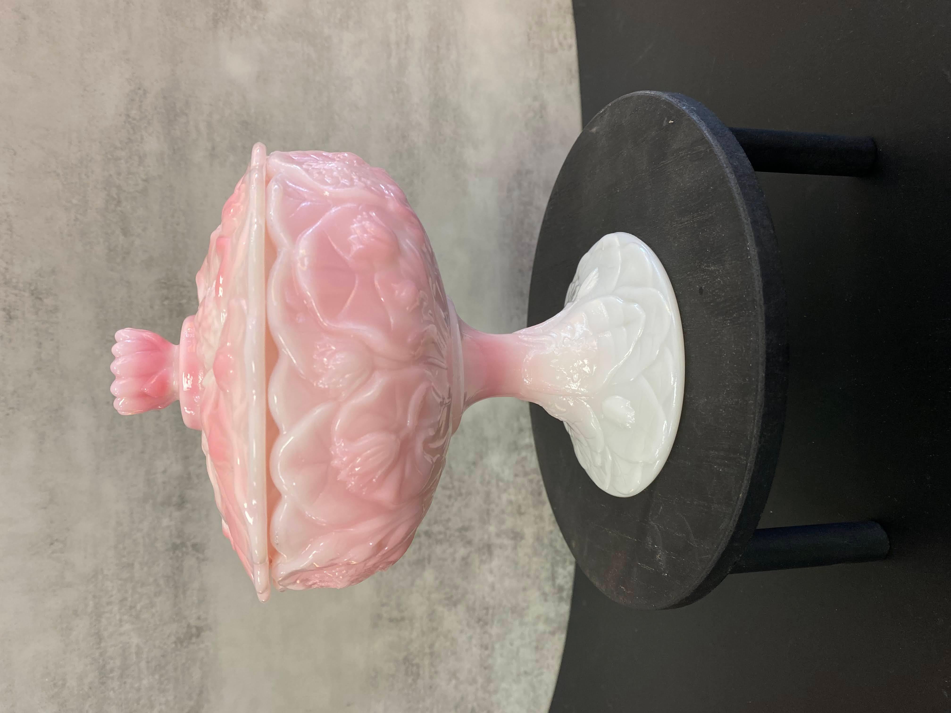 This rare collectible Fenton footed candy dish with fitted lid is from the Roselene Water Lily collection. This one-owner piece was purchased from the family of an avid collector and it was well cared for. No chips or cracks. 
The pink and white