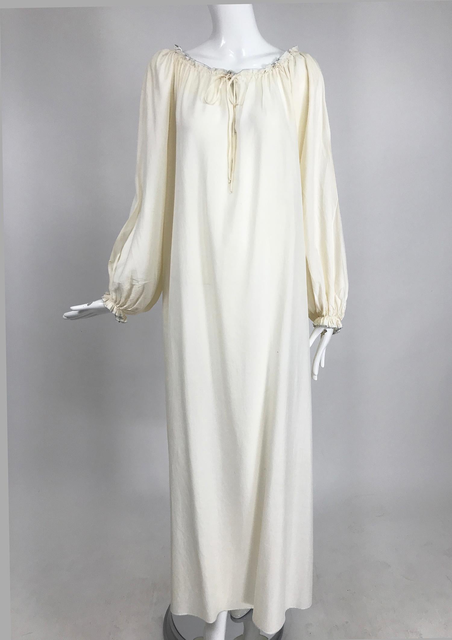 Vintage Fernando Sanchez cream silk bohemian maxi dress from the 1970s. Beautiful dress, the fabric is translucent, great worn with a belt (belt in photo, not included). Pull on dress has an open front drawstring gather, with center vent. Long full