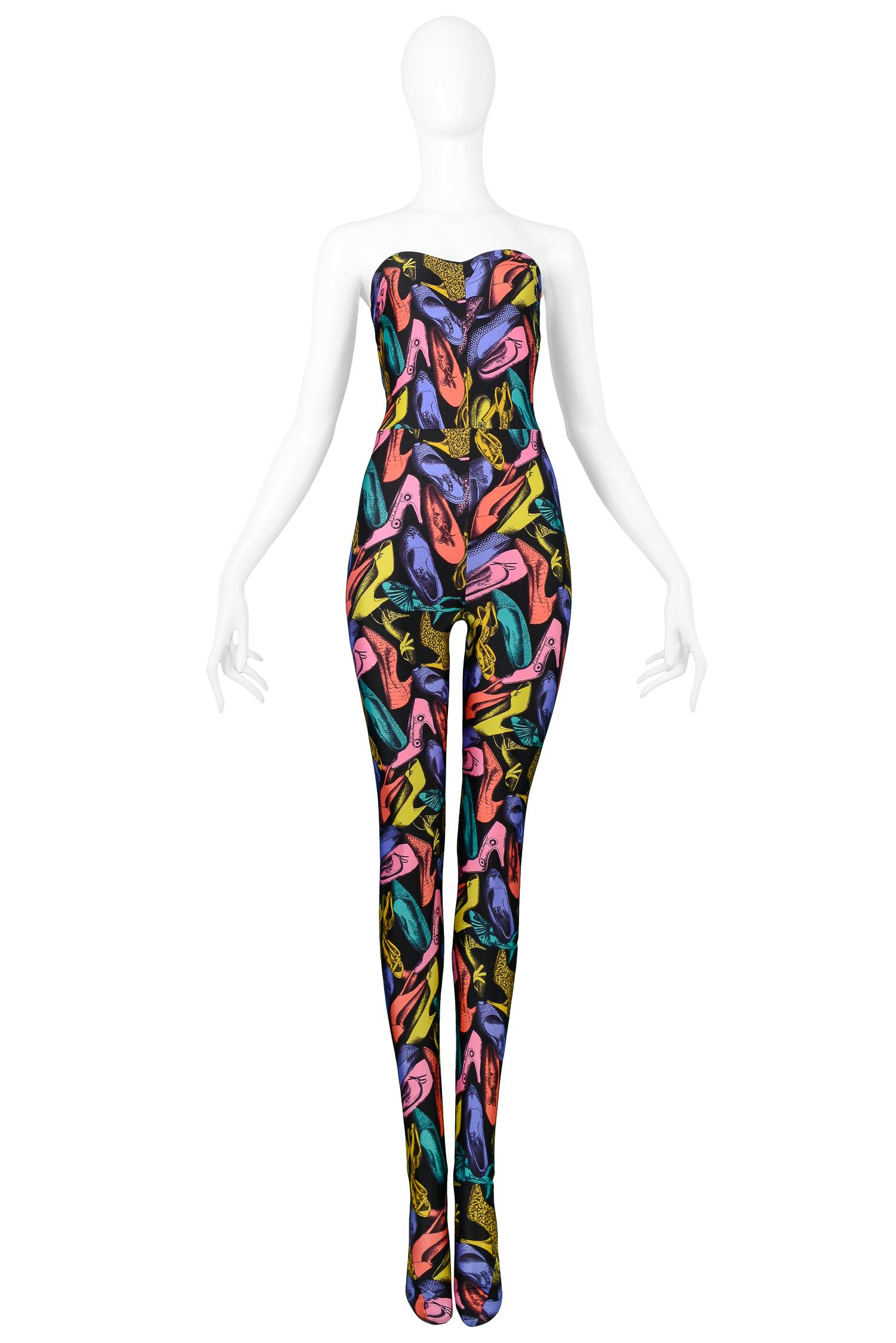 Vintage Salvatore Ferragamo multicolor shoe print silk jacket with lycra jumpsuit ensemble. The jacket features 3 gold buttons, high collar, fitted cut and is fully lined. The stretch lycra jumpsuit features a strapless sweetheart bodice and