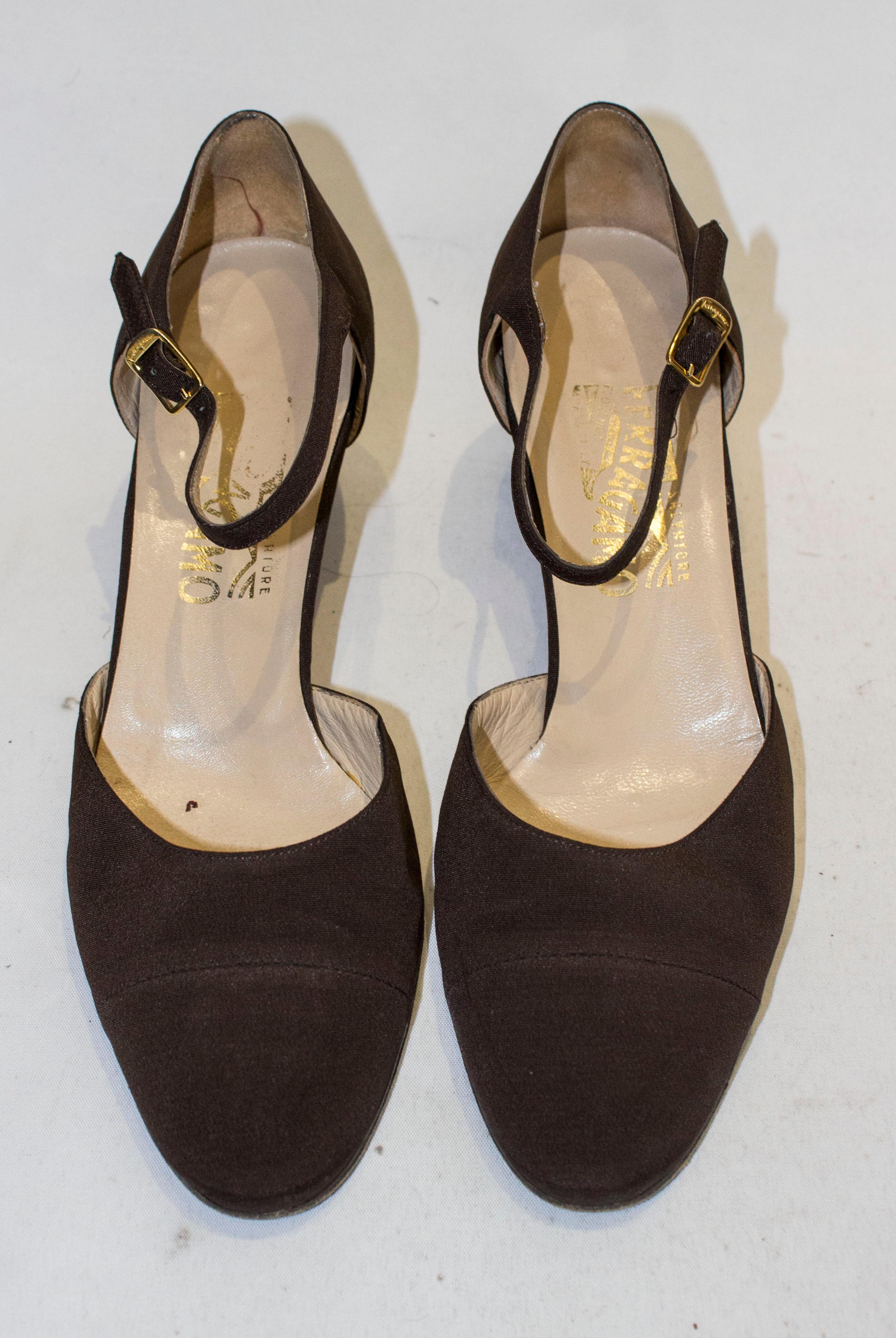 A chic pair of Ferragamo shoes . The shoes are in a nut brown grossgrain like fabric, with an ankle strap and 2'' heel.  They are marked size 8 1/2  .