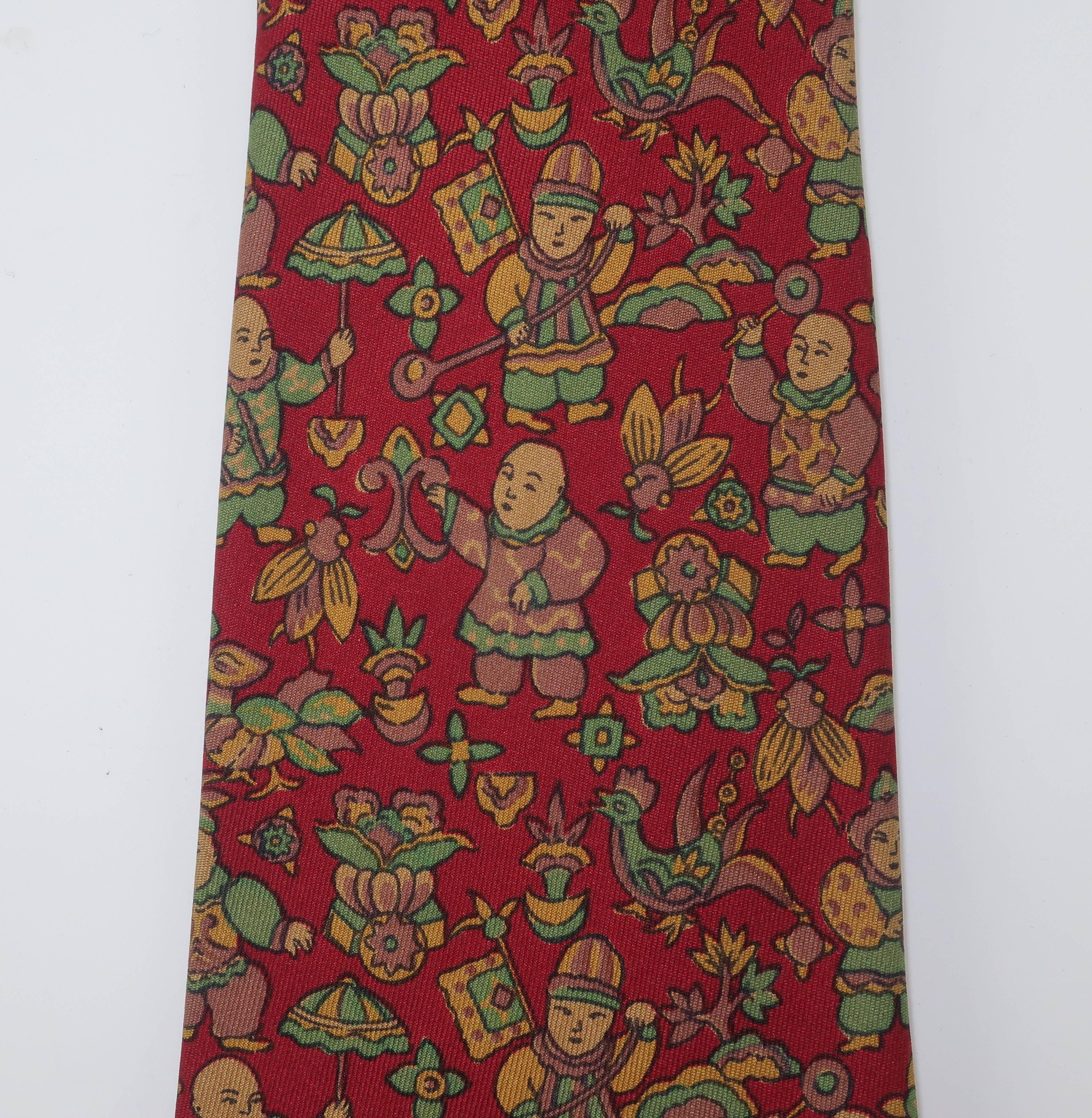 Ferragamo creates a menswear silk necktie with a whimsical motif depicting Asian figures with umbrellas, flags and instruments all in traditional costumes.  The rich background color is a deep burgundy red with shades of olive green, beige and light