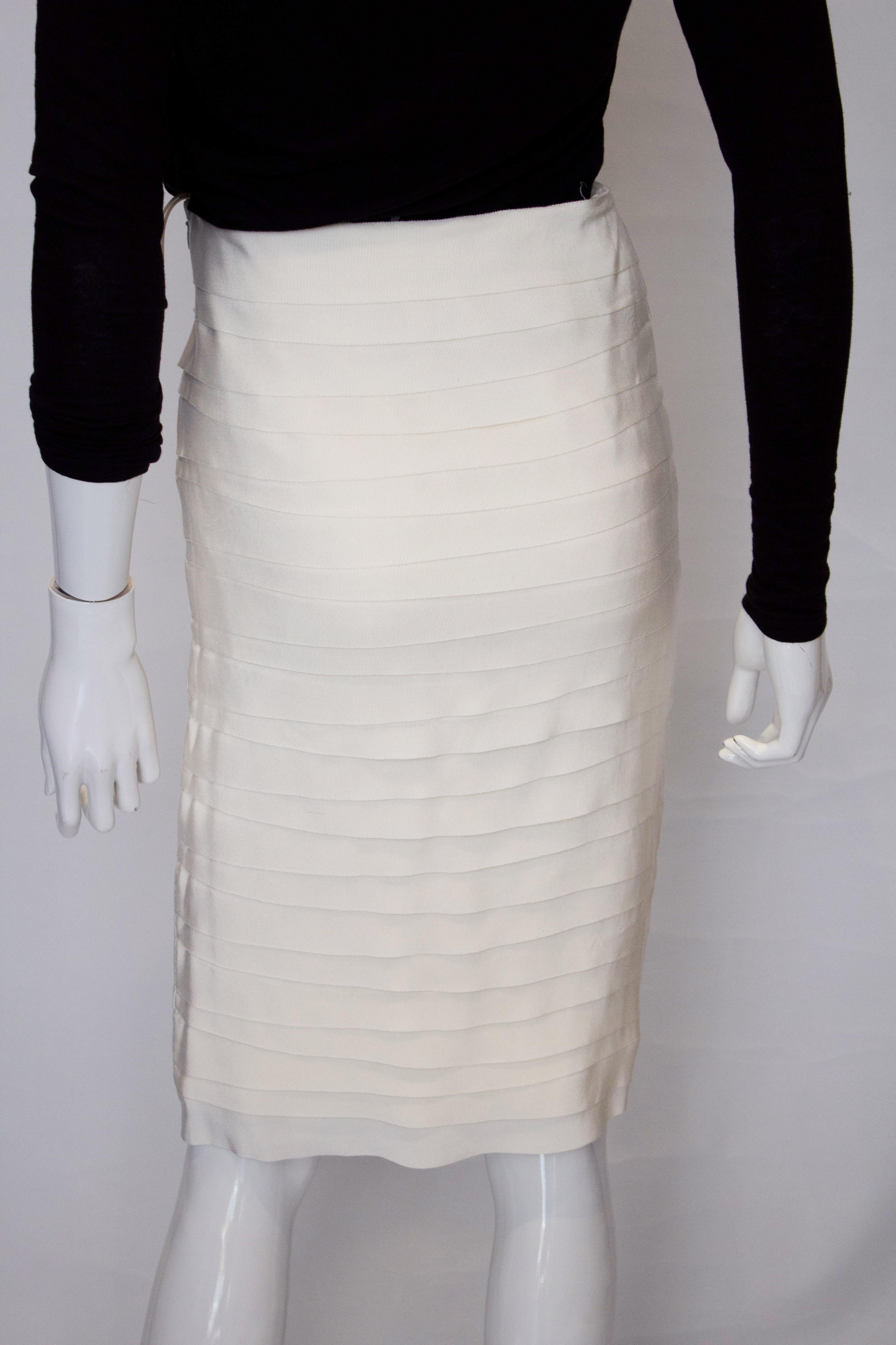 A chic vintage white skirt by Ferragamo. The skirt is made of horizontal rows of fabric with a zip opening on the left hand side.  It is fully lined.