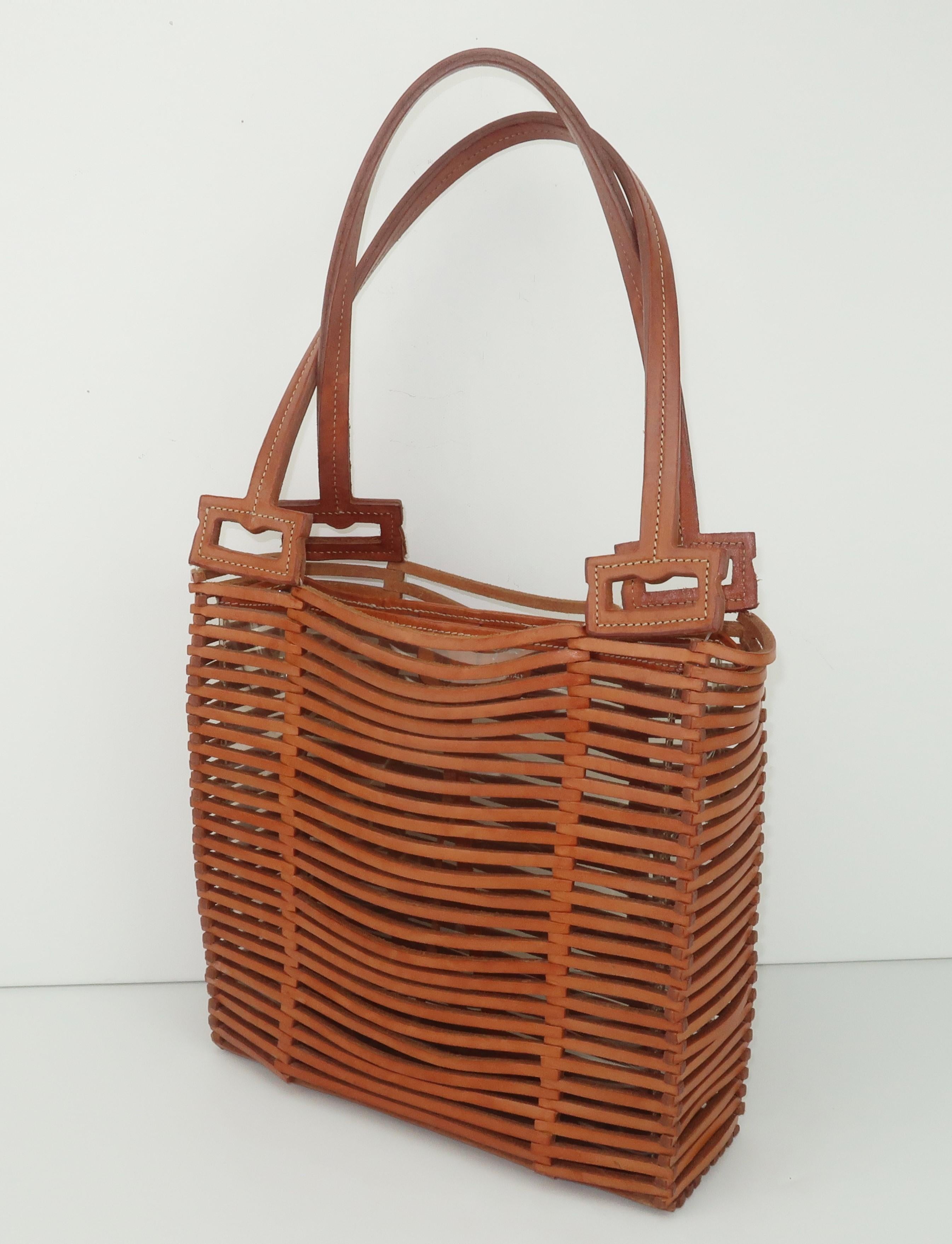 Vintage Ferragamo tan woven leather handbag with a tote style silhouette and a casual look perfect for warm weather seasons.  The clever design is reminiscent of the open weave bamboo bags from the 1940's but Ferragamo's version bears the fashion