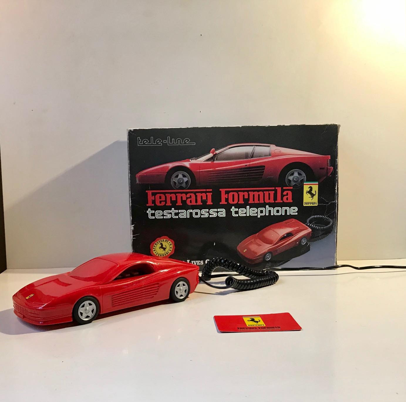 Unused vintage telephone in the shape of this red Ferrari Testarossa. Manufactured by Häger in Germany during the late 1980s. It is made from plastic and has press-buttons. Approved and licensed by Ferrari. It comes as a full set with outer box,