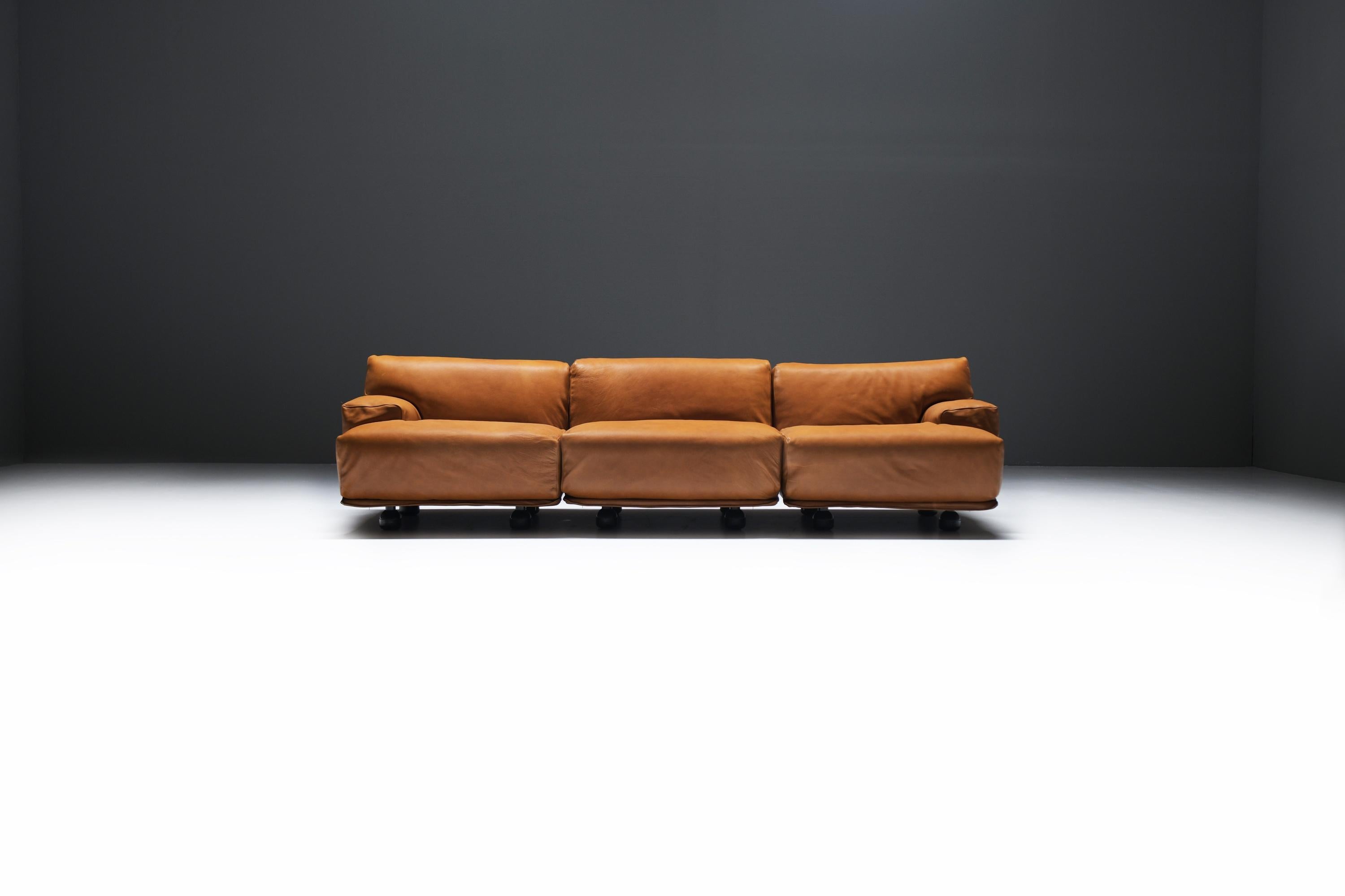 Great modular FIANDRA sofa.  Reupholsterd in new high quality cognac leather.
Designed by Vico Magistretti for CASSINA.

Characterized by its simplistic, round edges that are noticeable in the shape of the upholstery that underline the clear