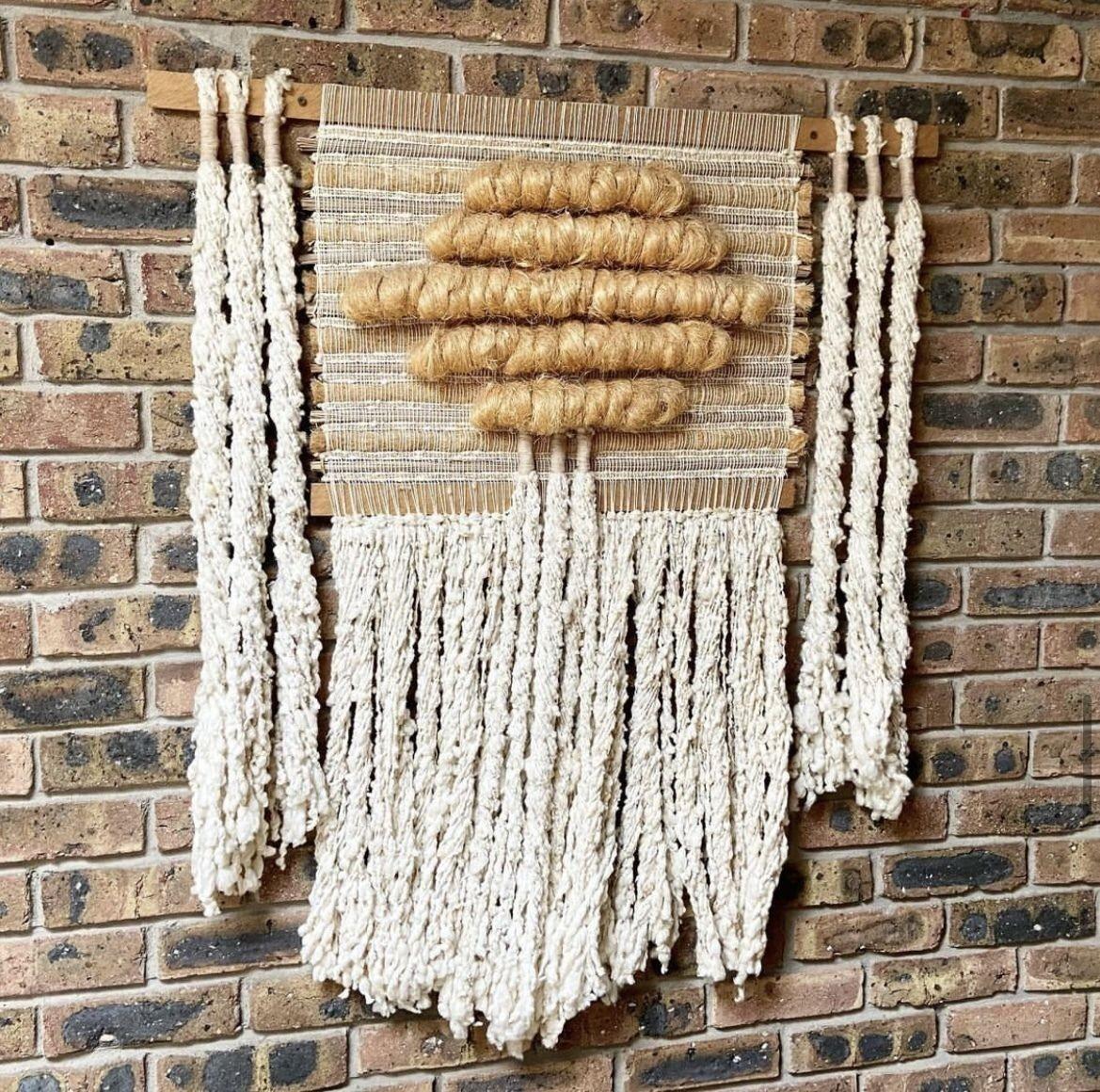 USA, 1960s
1960s handwoven textile piece in cream and natural colors. Beautiful vintage fiber art. Nice body, texture, and dimension to this piece, and in a great neutral colorway. Mounts via screws on the wooden rod. Estate purchase, no markings