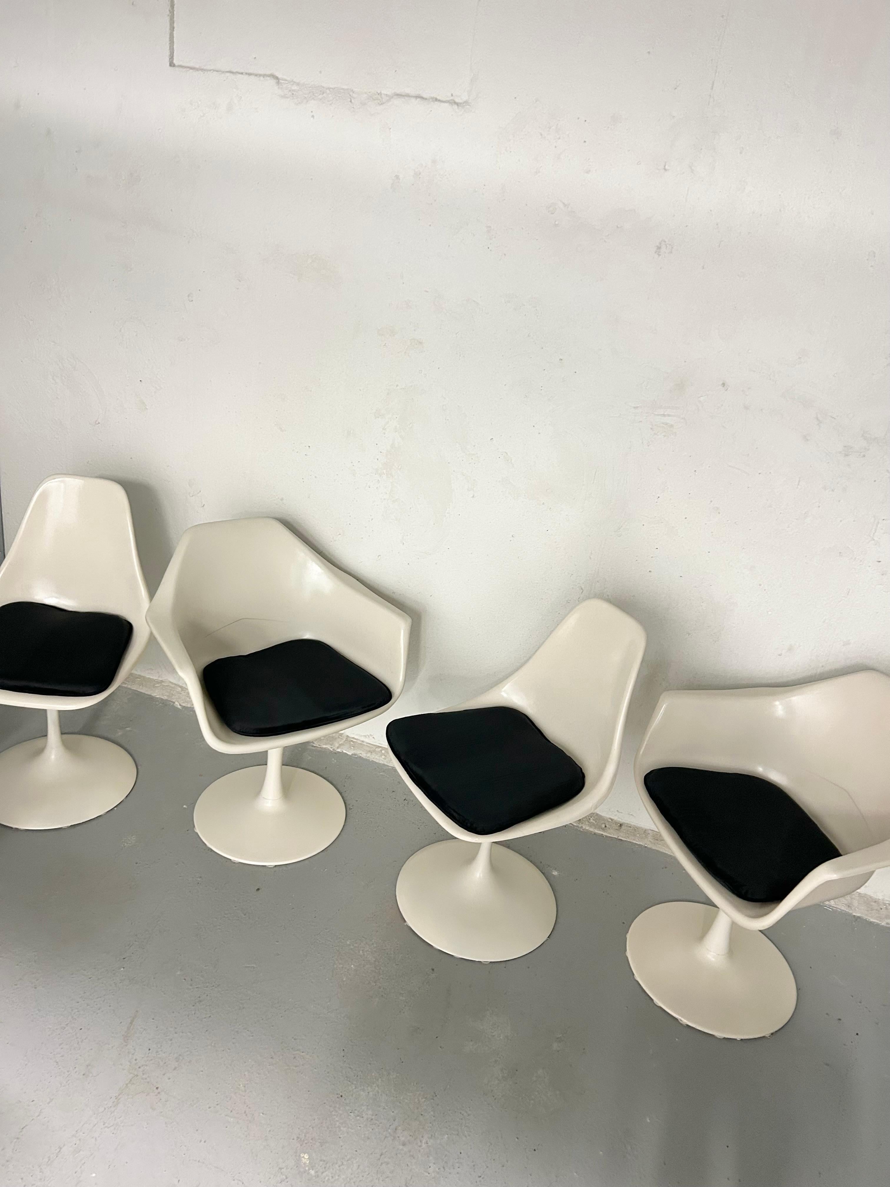 Vintage space age fiberglass swivel tulip chairs. In the style of Eero Saarinen. Manufacturer unknown. In good vintage condition. Black velvet cushions were purchased new to style the chairs and are not original but they are included. The two chairs