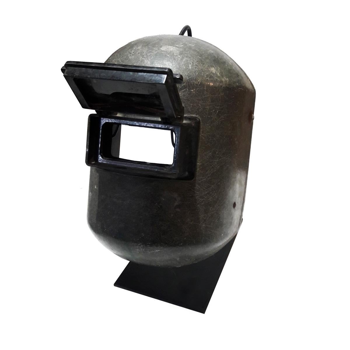 A welding mask with original eye-protective window, made in fiberglass, circa 1957. 
The Fibre-Metal Products Co. was formed in 1905 when its founder invented the first protective welding helmet out of fiberglass. This fully functional, very well