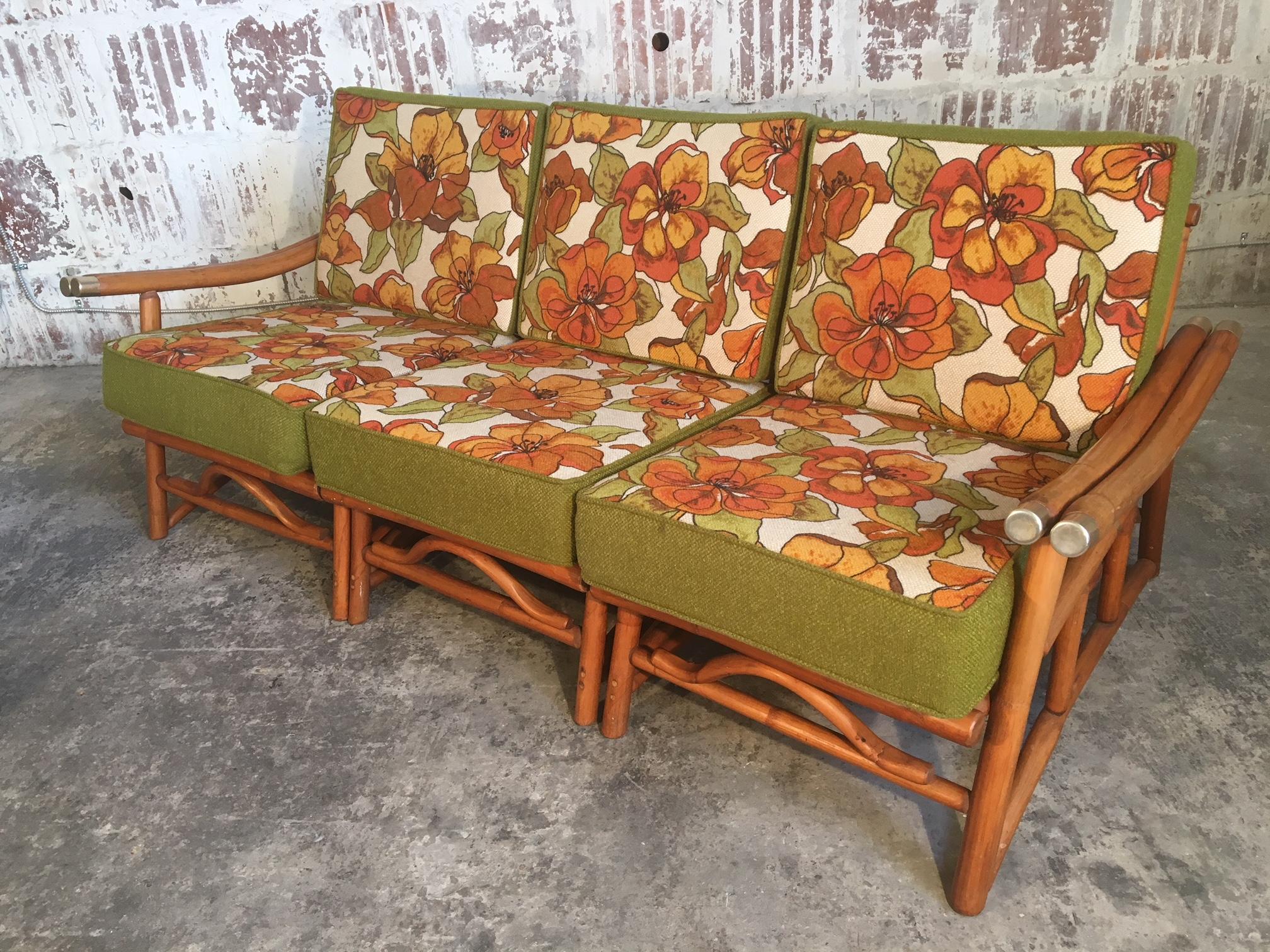 Vintage Ficks Reed bamboo at it's finest. Three-piece sectional sofa with floral upholstered cushions and a low, lounge-like stance. Very good condition with only very minor signs of age appropriate wear.  Professional reupholstery available, ask
