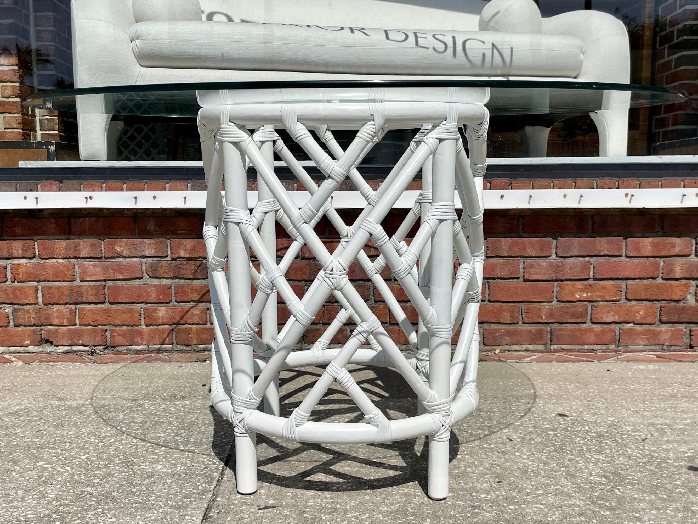 Fabulous vintage Ficks Reed Chippendale pedestal dining table with glass top. The round rattan base is freshly lacquered white. The detail work of the rattan is just great with Palm Beach Style design. Some minor chips on glass top. It will hold a