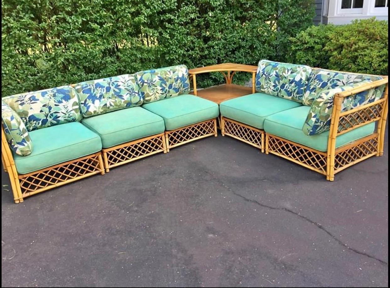 Six piece Ficks Reed sectional sofa composed of five seating sections and a table. Original cushions available in fair condition. Structurally sound and in very good condition. Corner seat sections measure 30” by 30” with 28” height. Armless seat