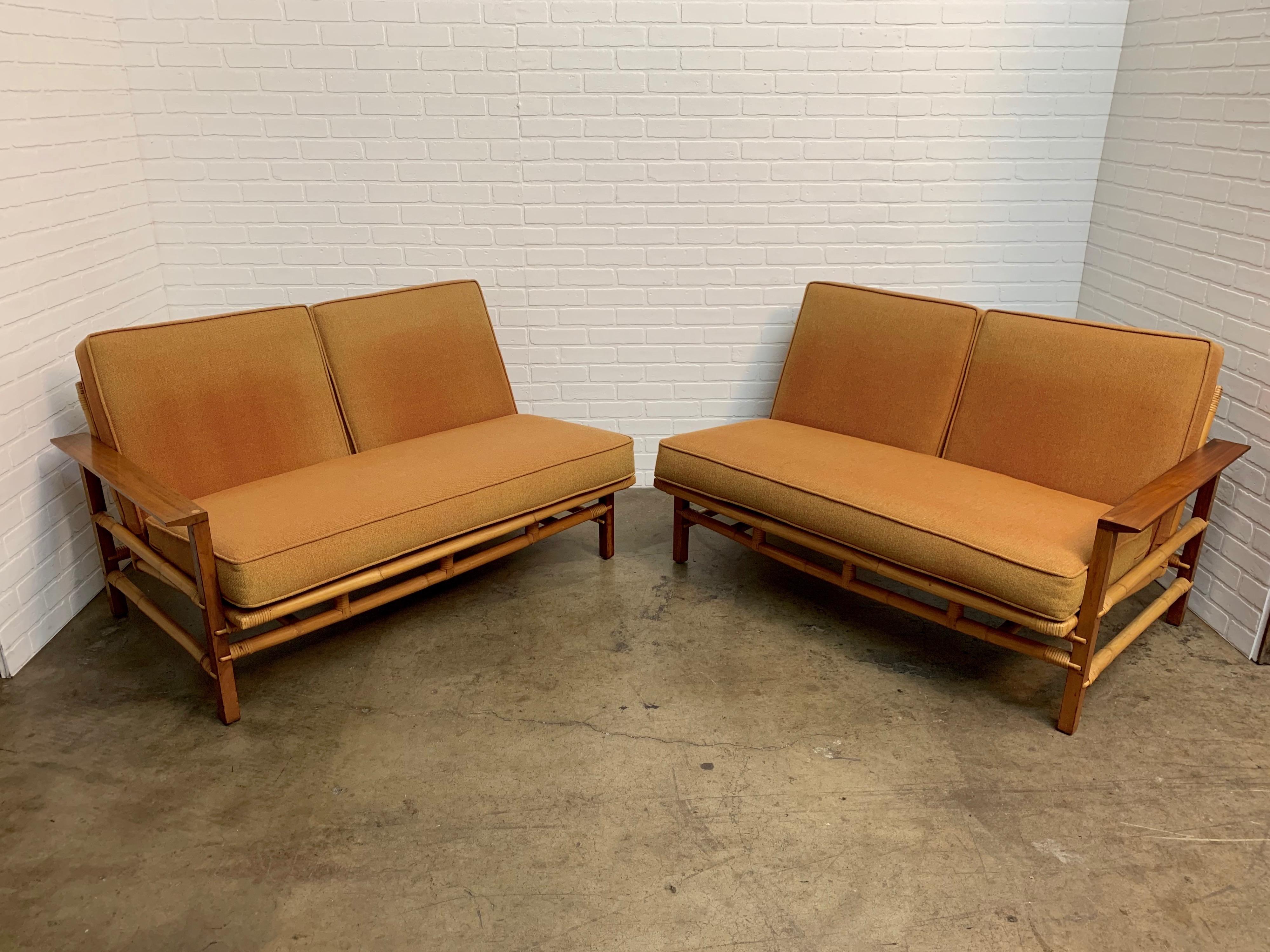 Rare combination of walnut with rattan love seats by Ficks Reed that can be used as one long sofa or as a corner unit or a pair 
Measurements with out cushions 26.75