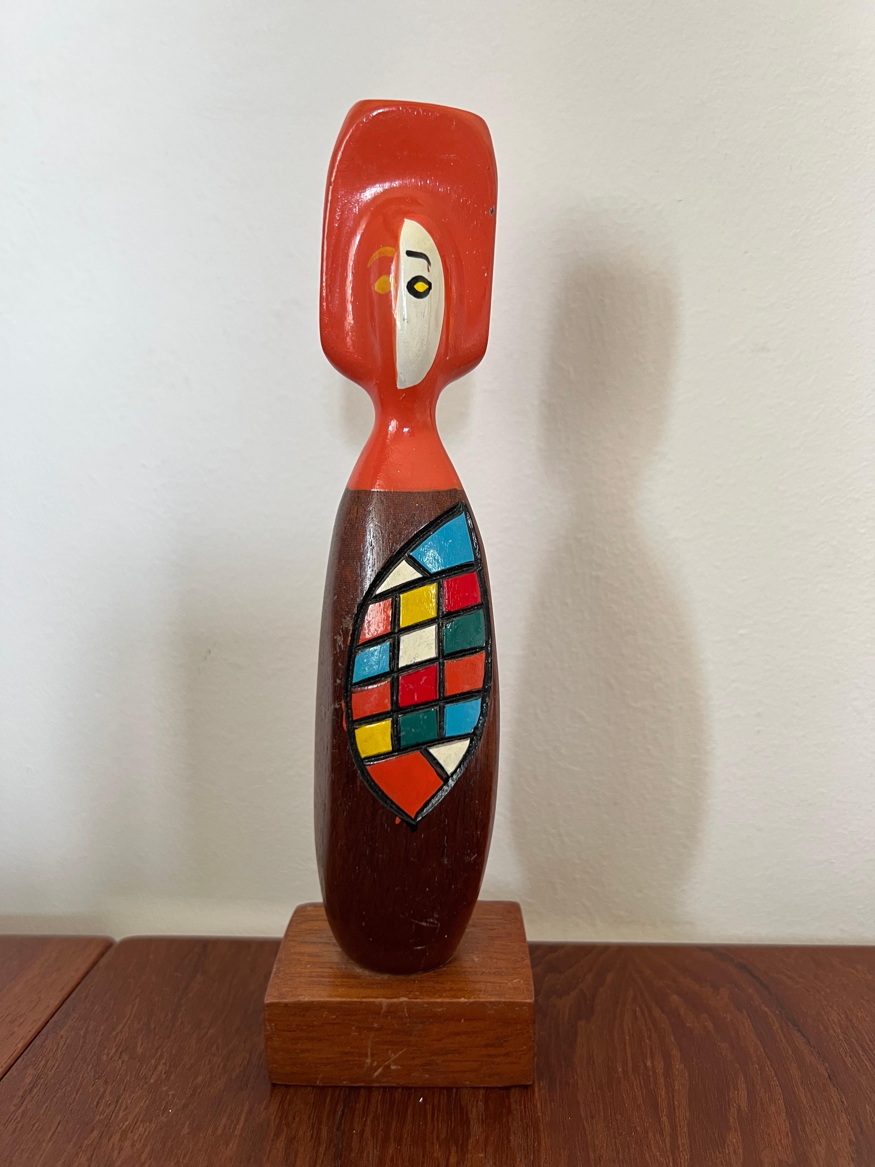 Figural abstract object deco figure Mid-Century Modern.
Great object is painted in a beautiful color combination. Created from teak wood with many details. It stands on a small pedestal. The figure has something very graceful. Inspired by the