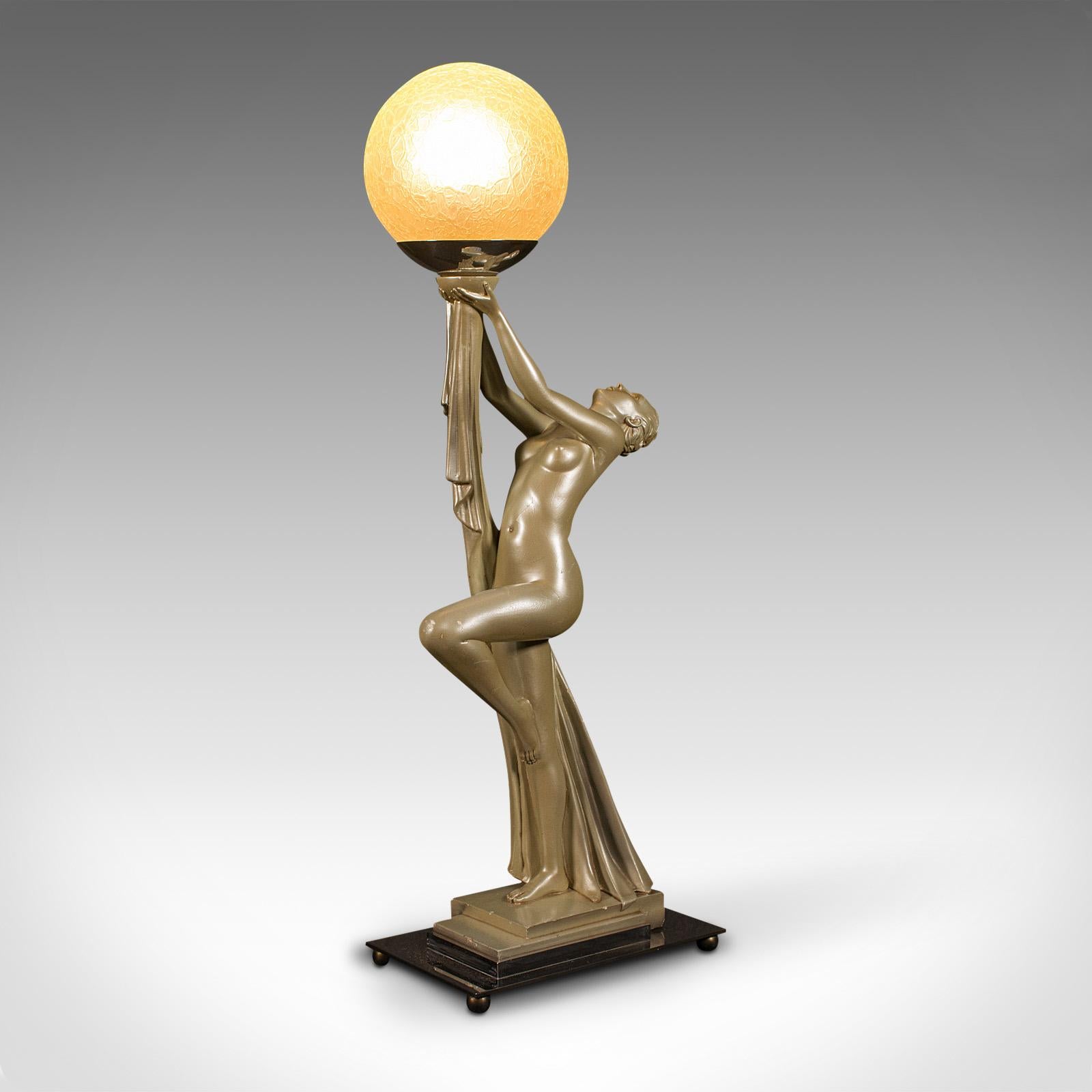 This is a vintage figural table lamp. An English, metallic plaster desk light in Art Deco taste by Leonardine, dating to the early 20th century, circa 1930.

Striking Art Deco lamp with the timeless nude female form
Displays a desirable aged