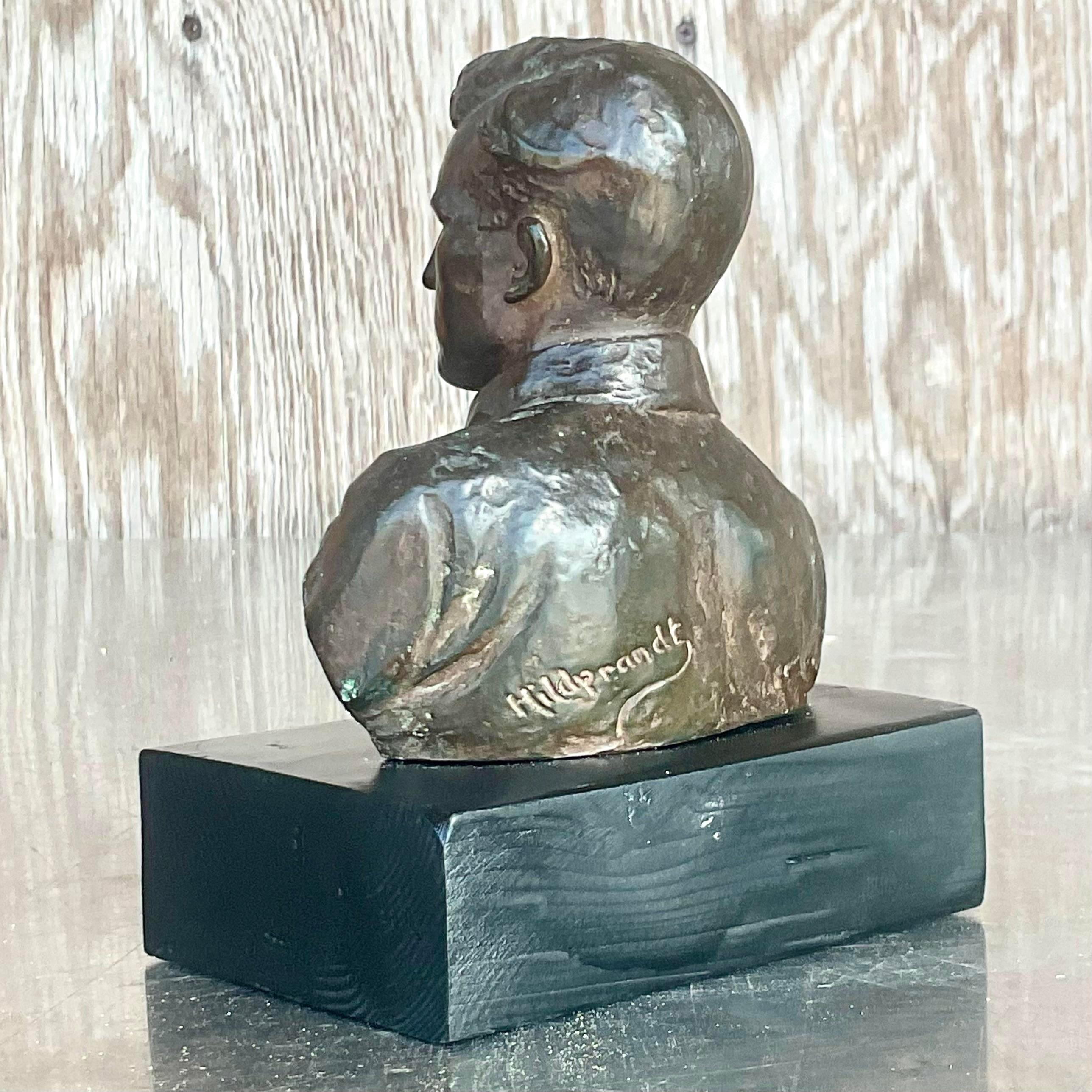 A fabulous vintage Boho plaster bust of man sculpture. A beautiful patinated bronze finish on a chic black plinth. Signed by the artist. Acquired from a Palm Beach estate. 