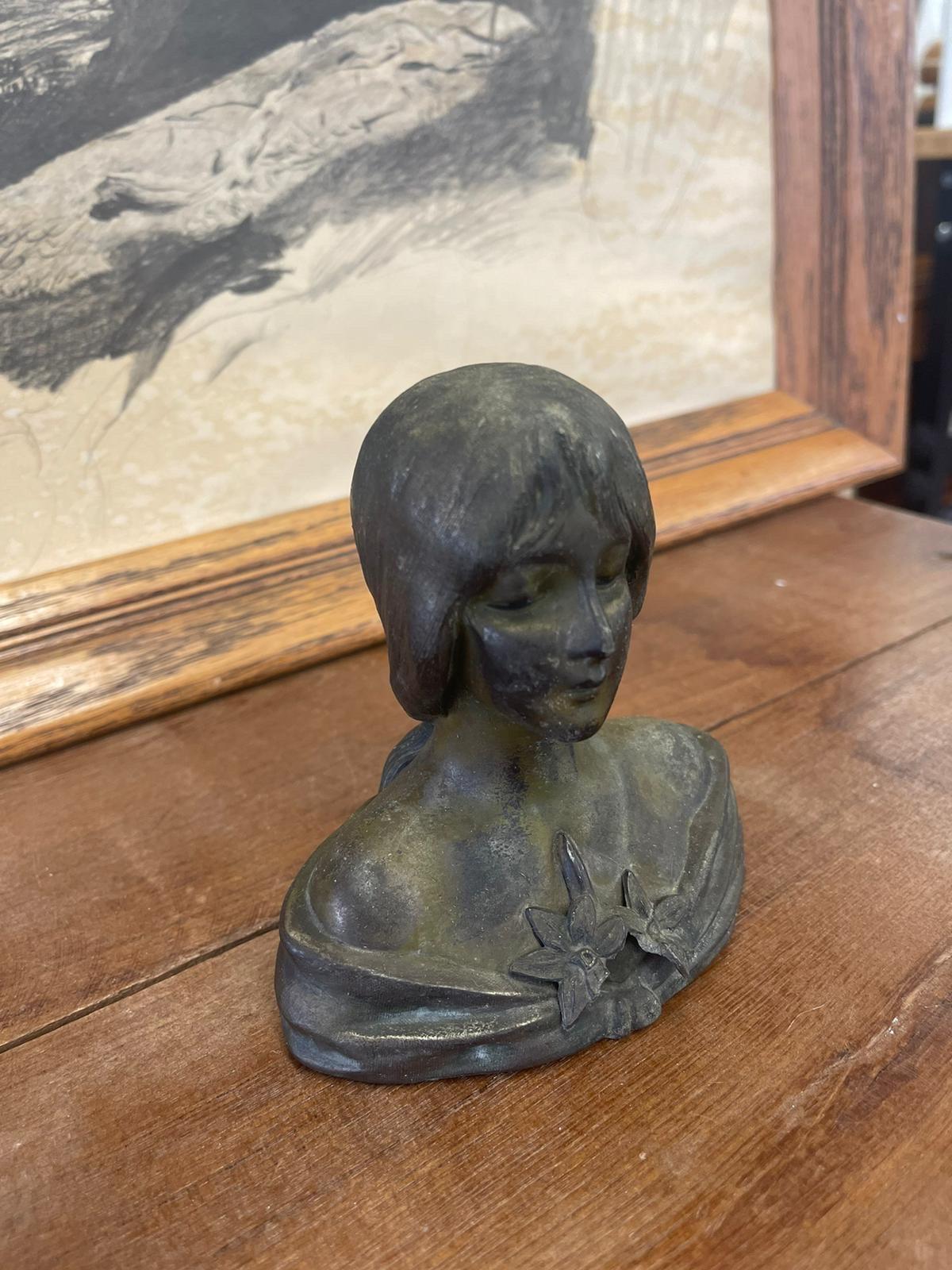 Antique Style Unsigned Sculpture of a Woman with Flower Detail. Pentina Consistent with Age.

Dimensions. 5 W ; 5 D ; 3 H
