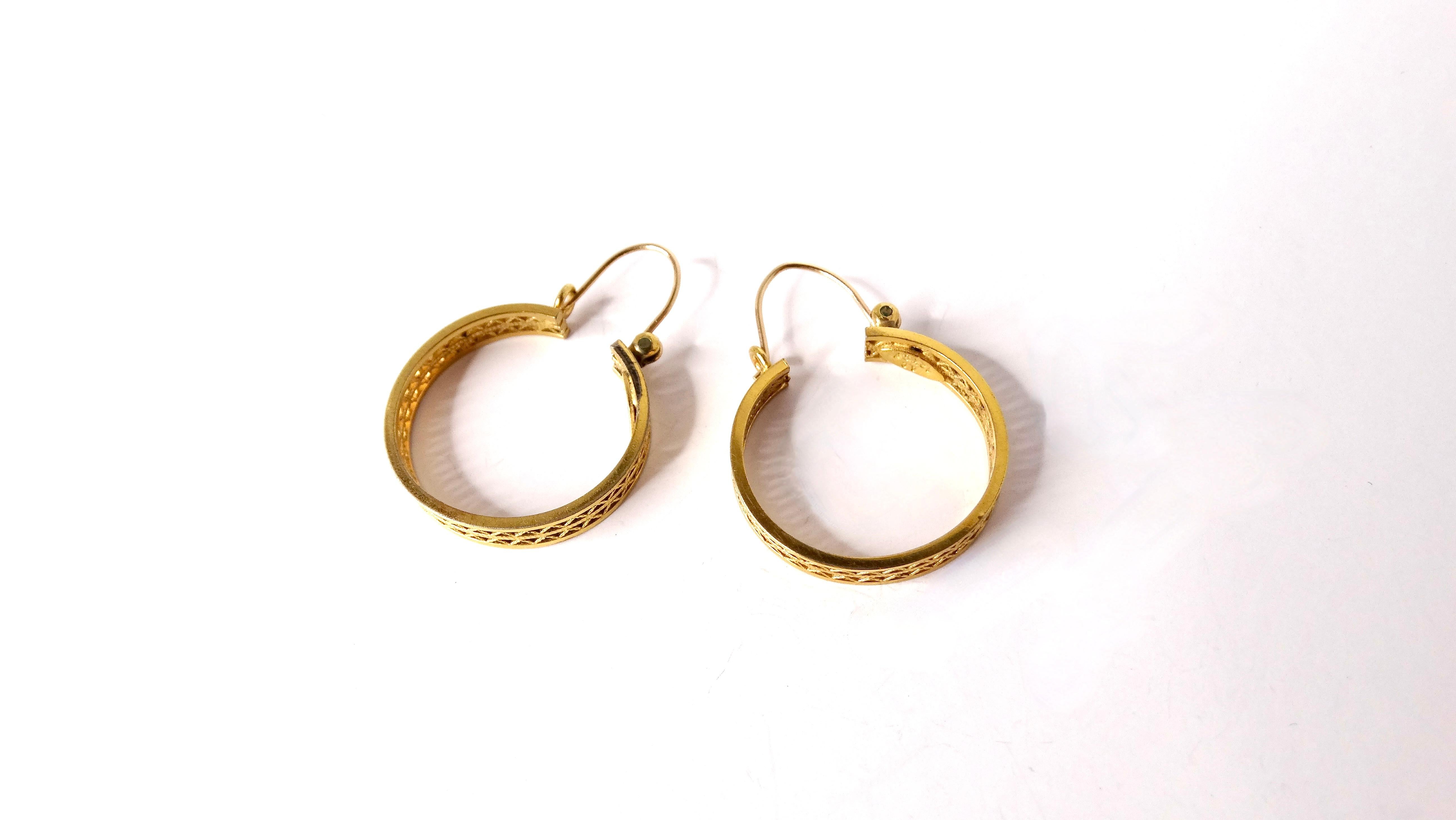 The Vintage Filigree 12k Yellow Gold Filled Hoop Earrings are a stunning accessory that exudes timeless elegance. Crafted with intricate filigree openwork detailing, these earrings feature a luxurious yellow gold finish that catches the light