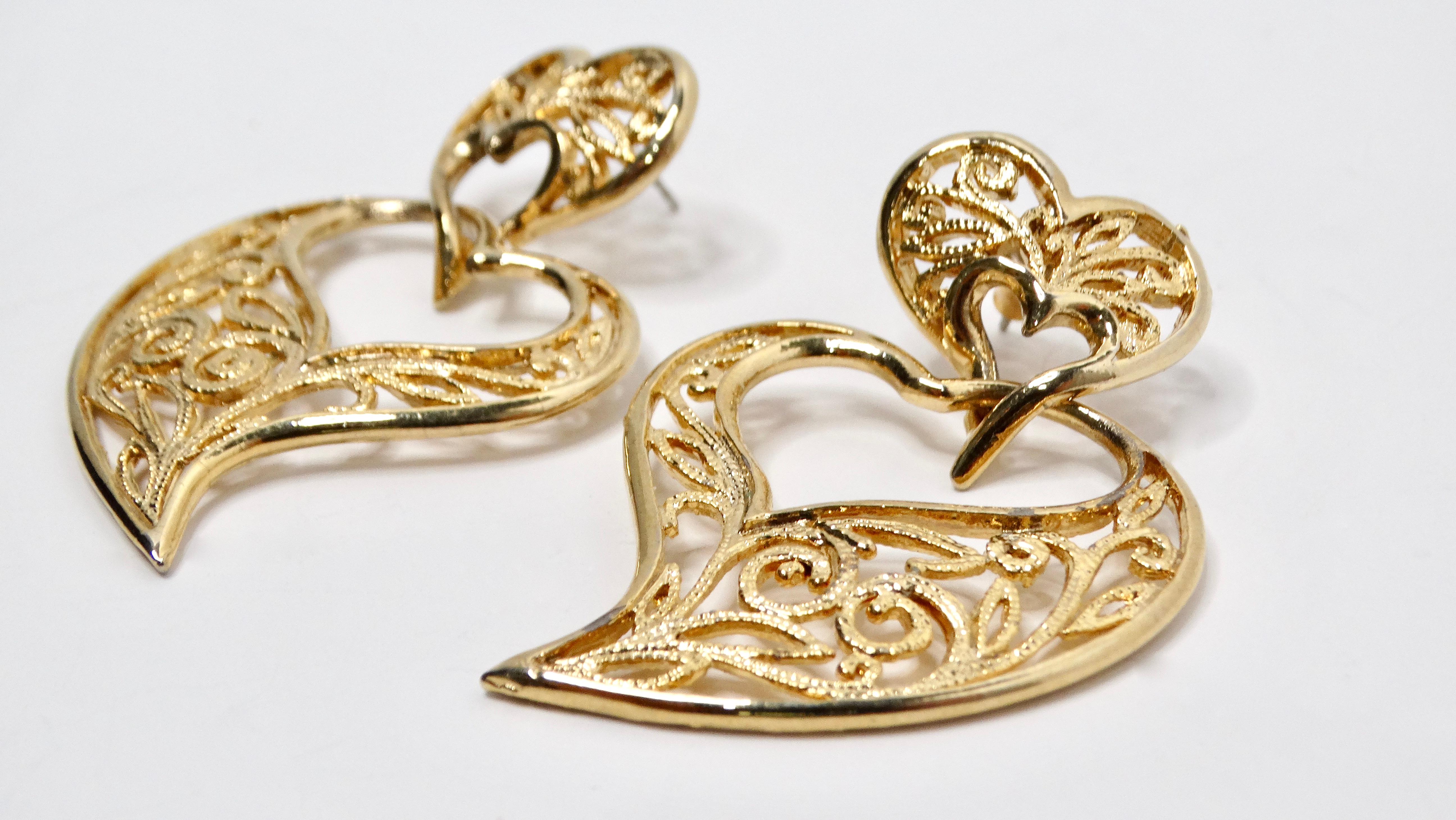 The Vintage Filigree Heart 14k Gold Plated Dangle Earrings exude timeless elegance and charm, perfect for adding a touch of sophistication to your ensemble. Crafted with intricate filigree detailing, these earrings feature a captivating heart design