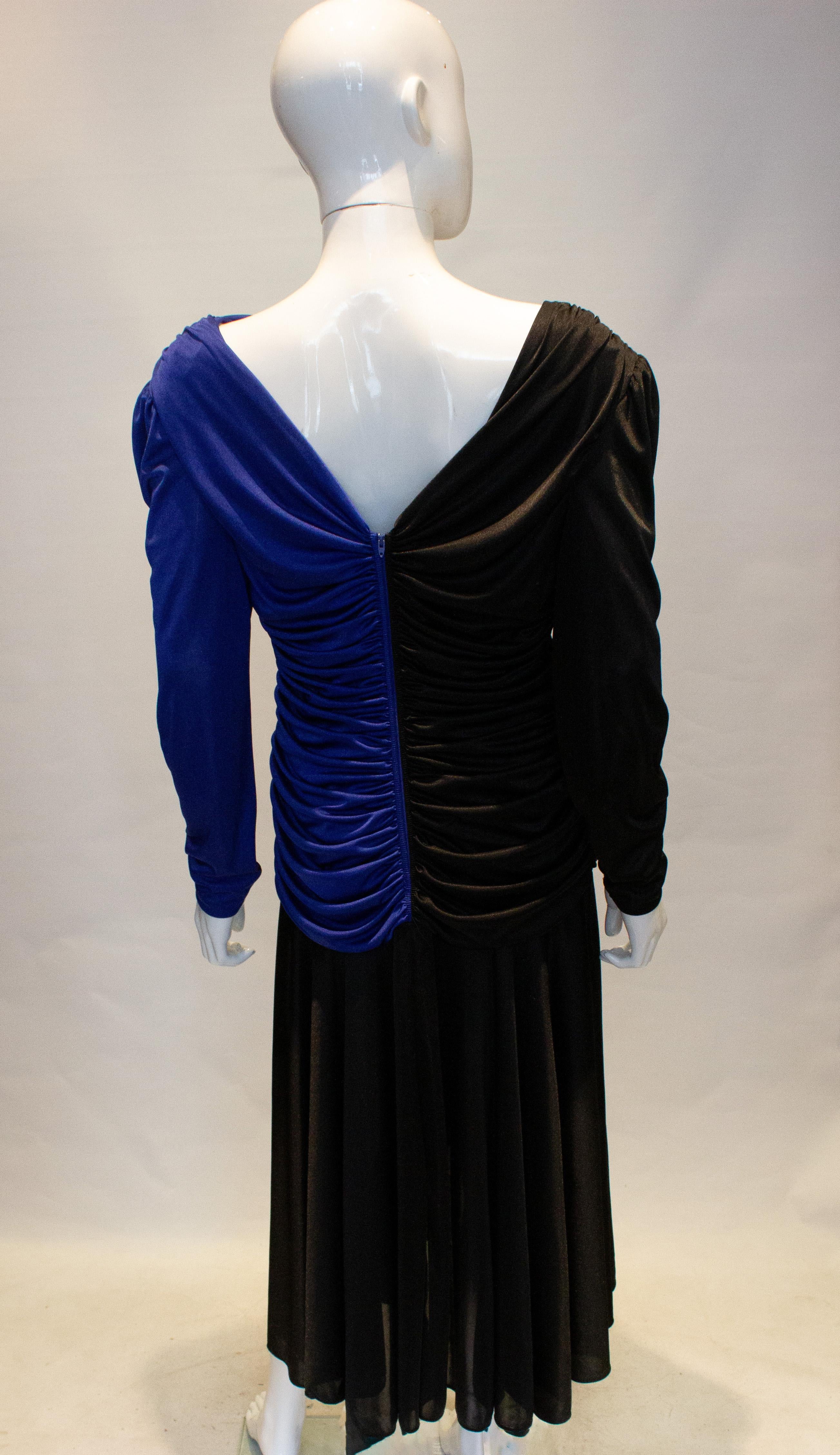 A very 1980s , but easy to wear evening dress by Filigree. The dress is in a blue and black combination with gathering and sequin detail.  It has a central back fastening , is shorter at the front and great for dancing. Measurements: Bust 38'',